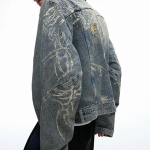 Model wearing a boxy fit cropped denim jacket in an urban setting