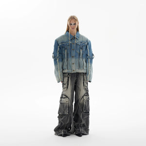 Model wearing oversized distressed denim jacket with baggy pants