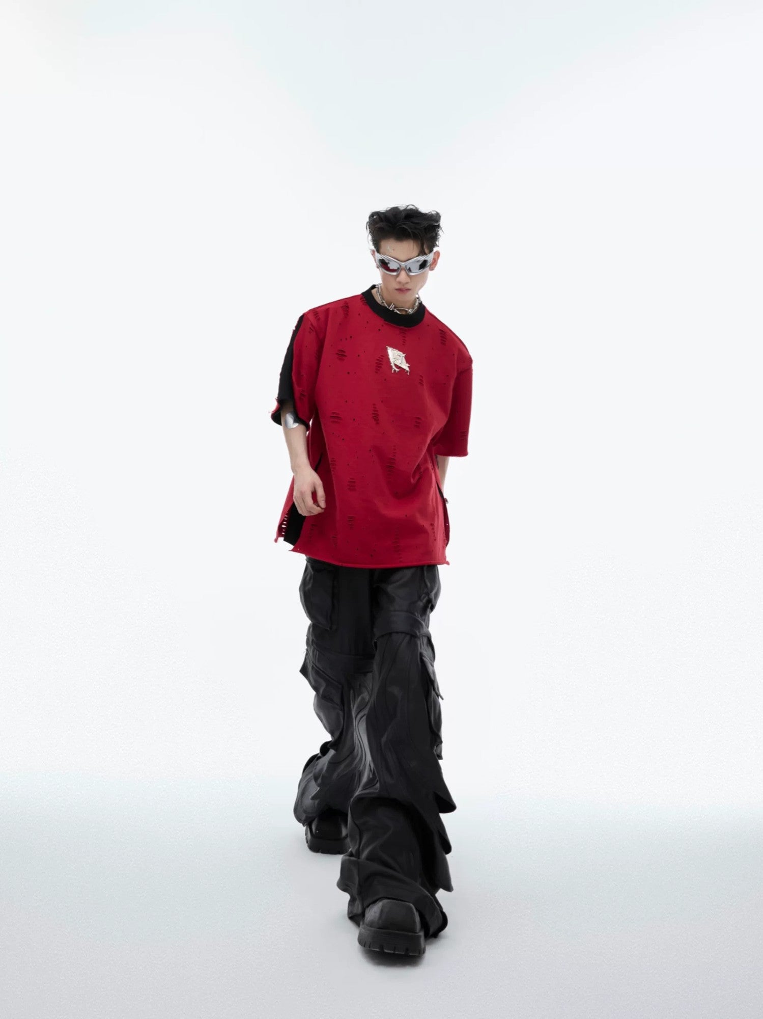 Full body shot showing the loose fit of the shoulder pad streetwear tee