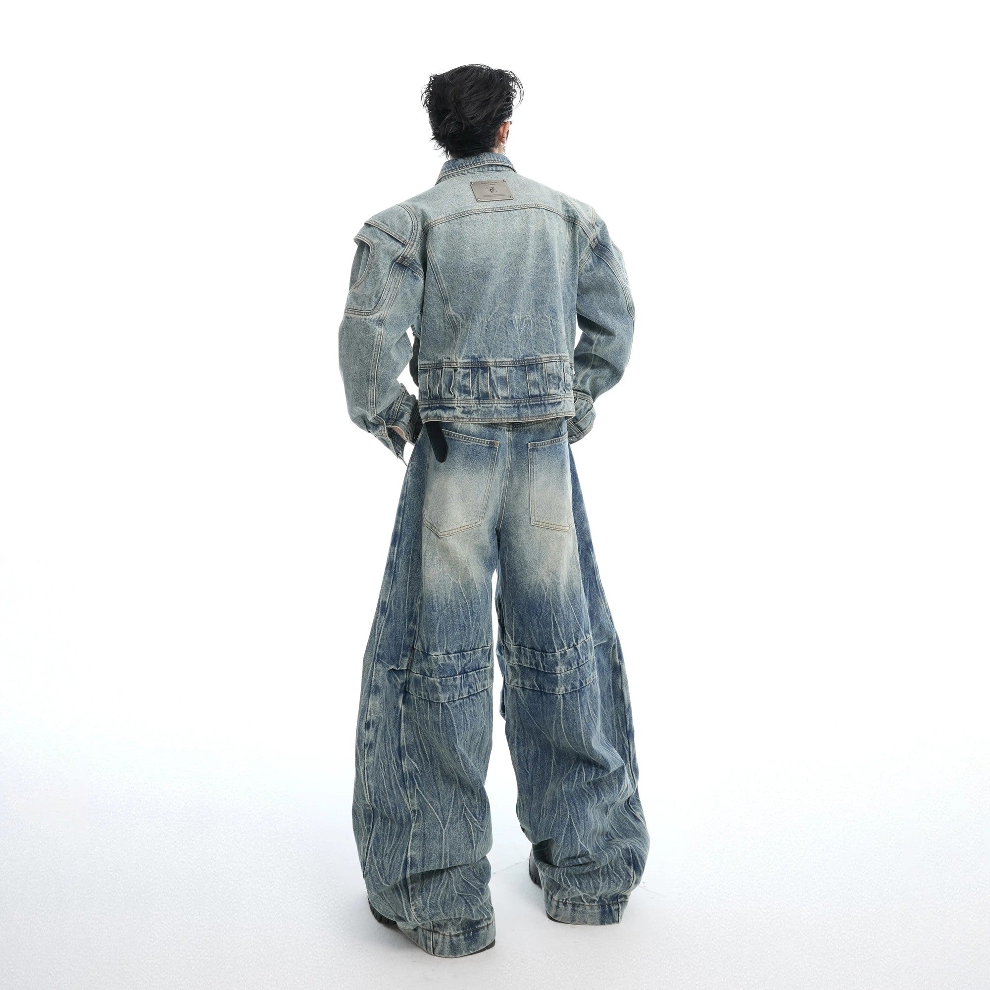 Close-up of the unique 3D armor-style pleated stitching on the denim sleeve.