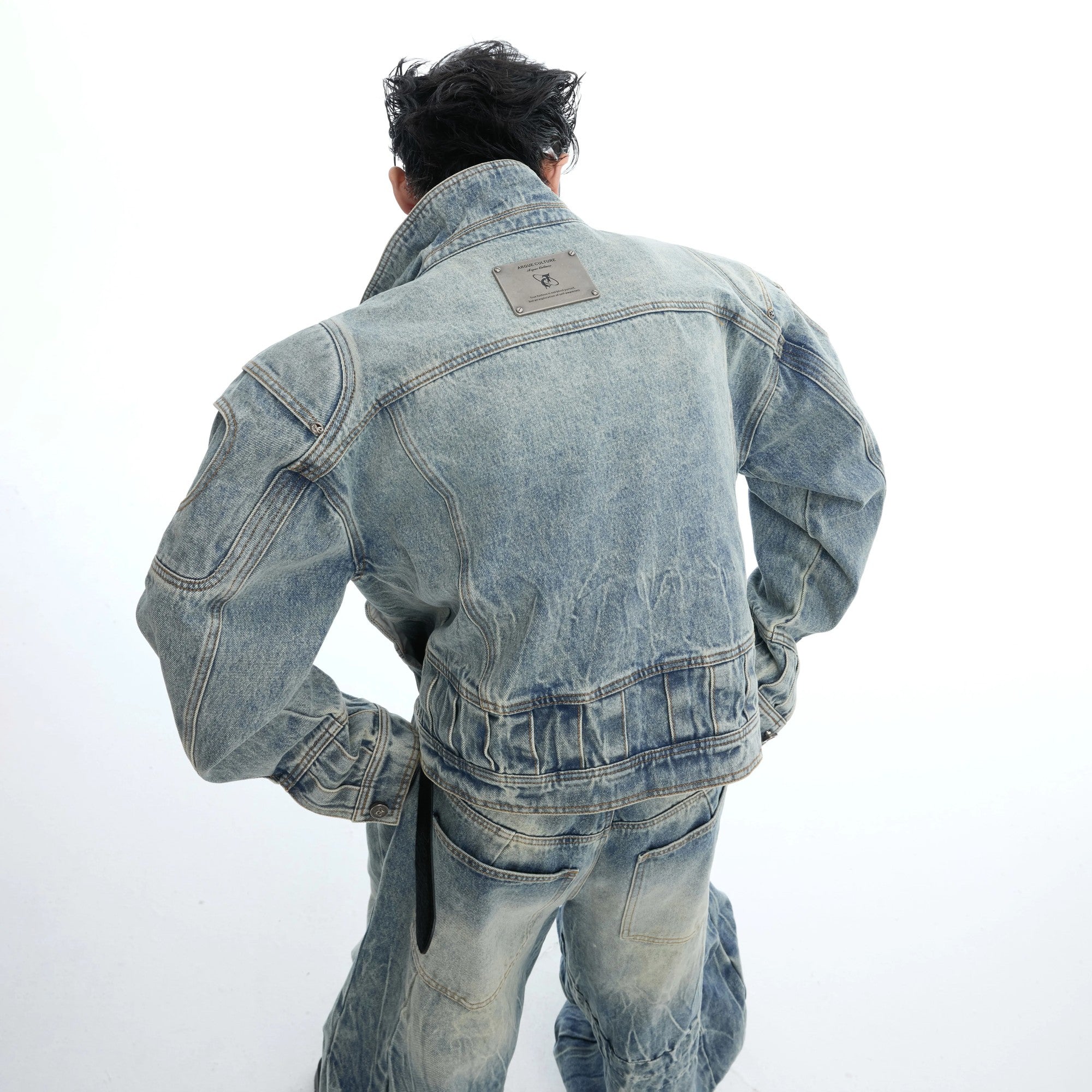 Back view of the distressed blue denim jacket showing premium slub texture.