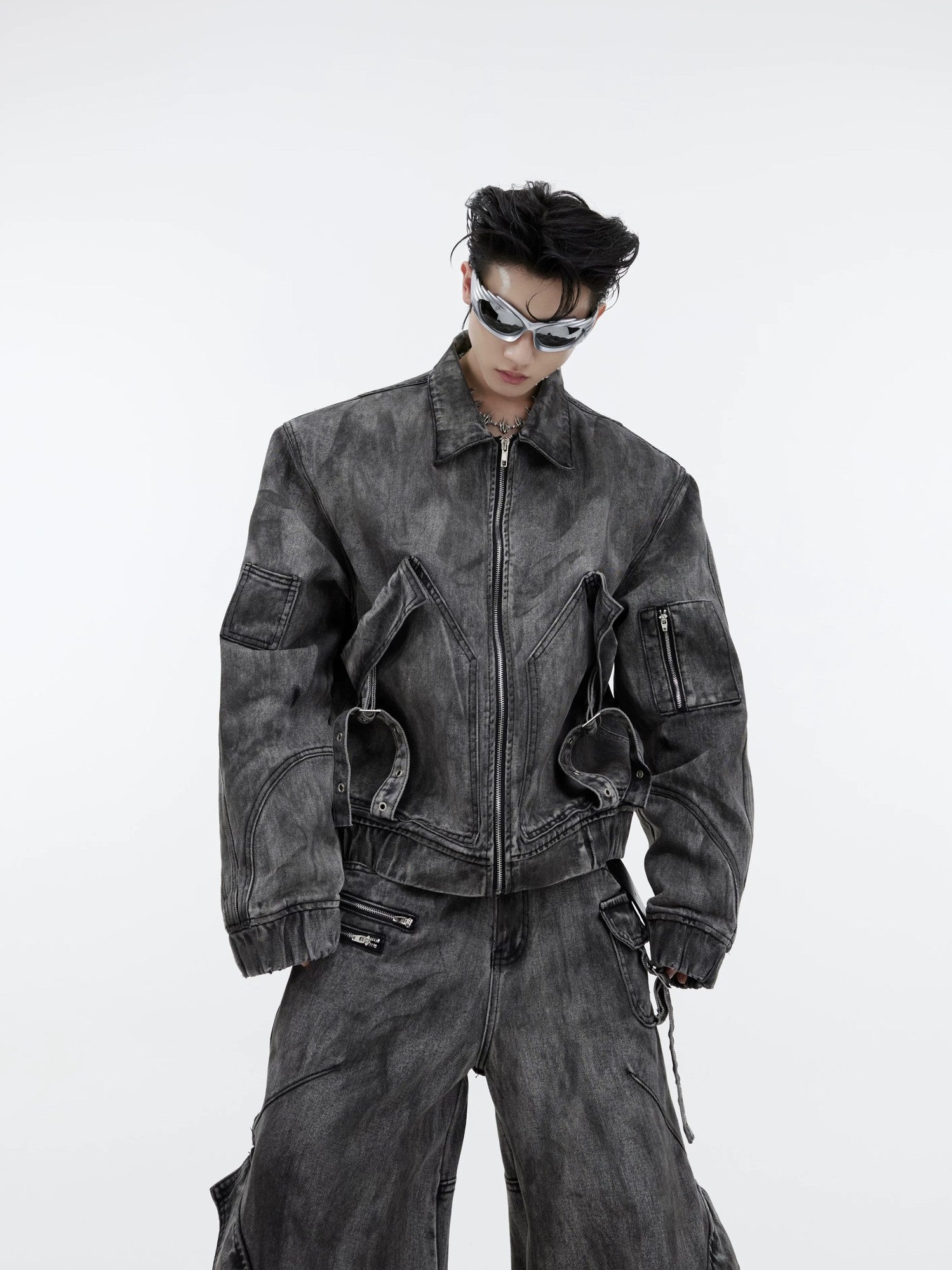 Close-up of Distressed Denim Jacket with Metal Eyelets and Zippers