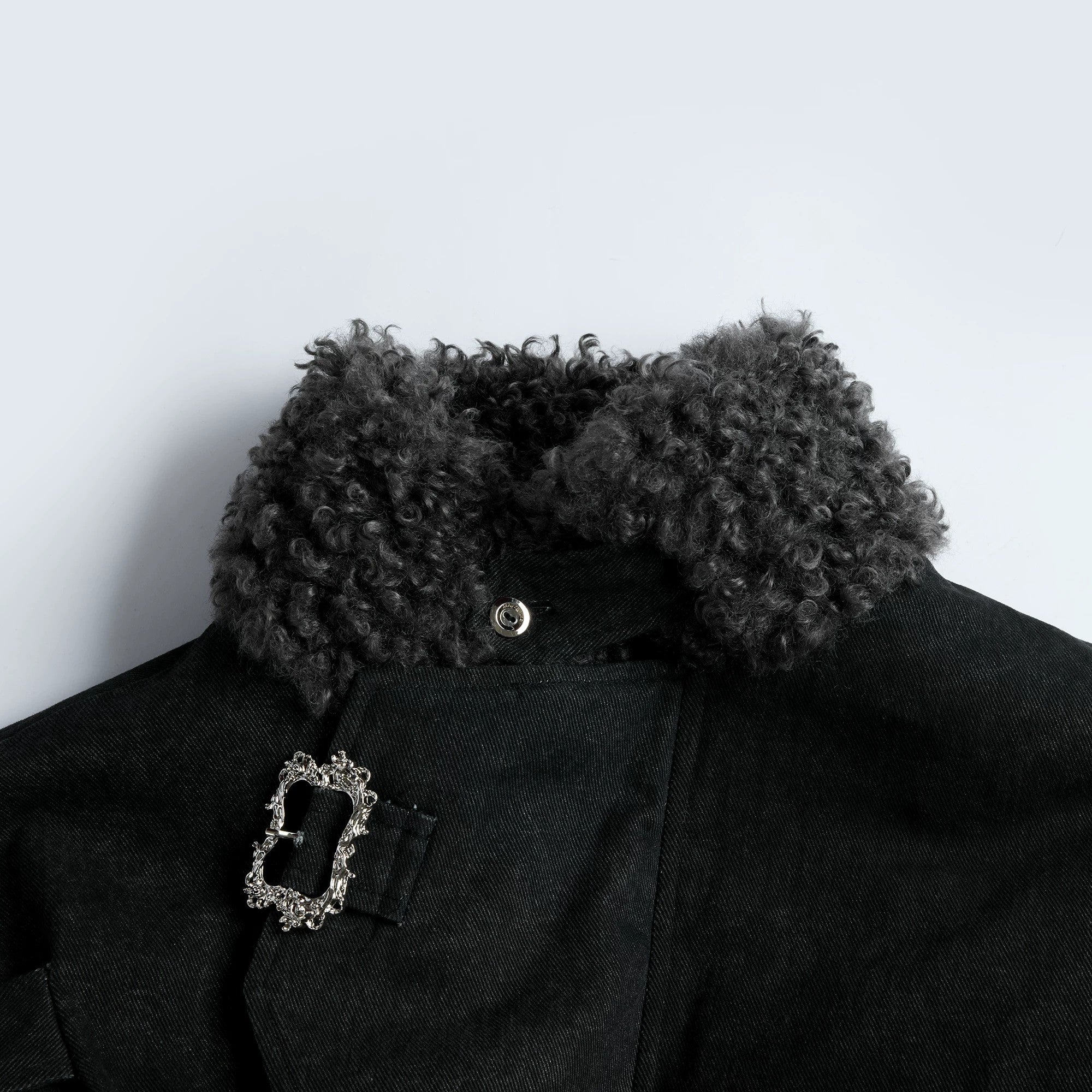 Engraved vintage metal button details on washed cotton fabric