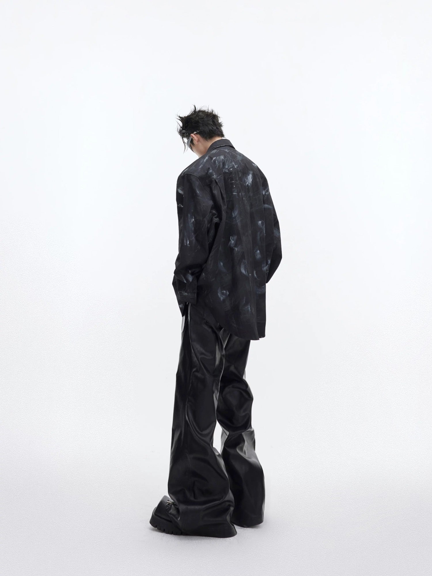 Model wearing the white hand-painted shirt in an urban street setting