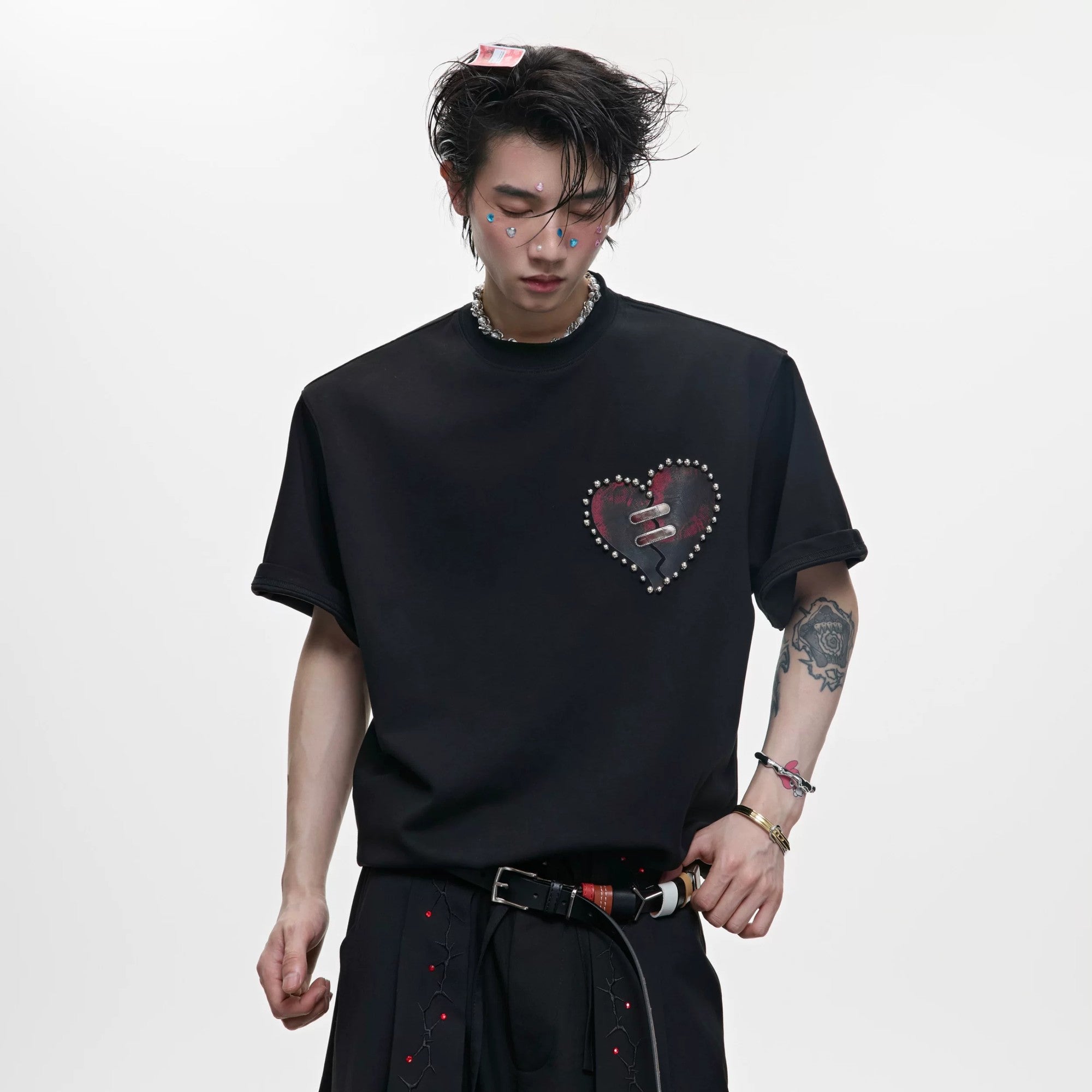 Model wearing a white slim fit t-shirt with heart graphic