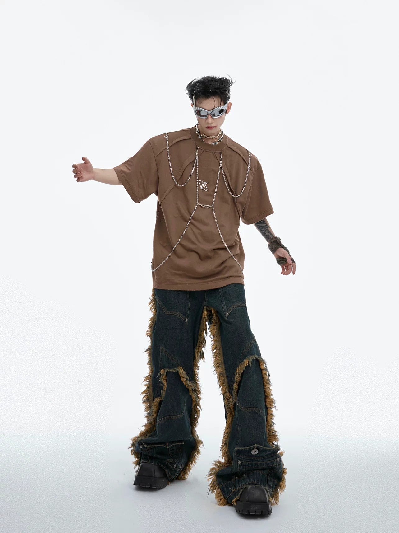 Model wearing distressed black chain tee in urban setting