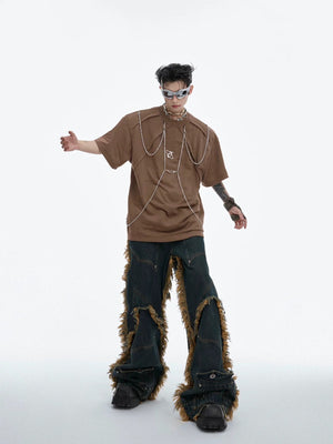 Model wearing distressed black chain tee in urban setting