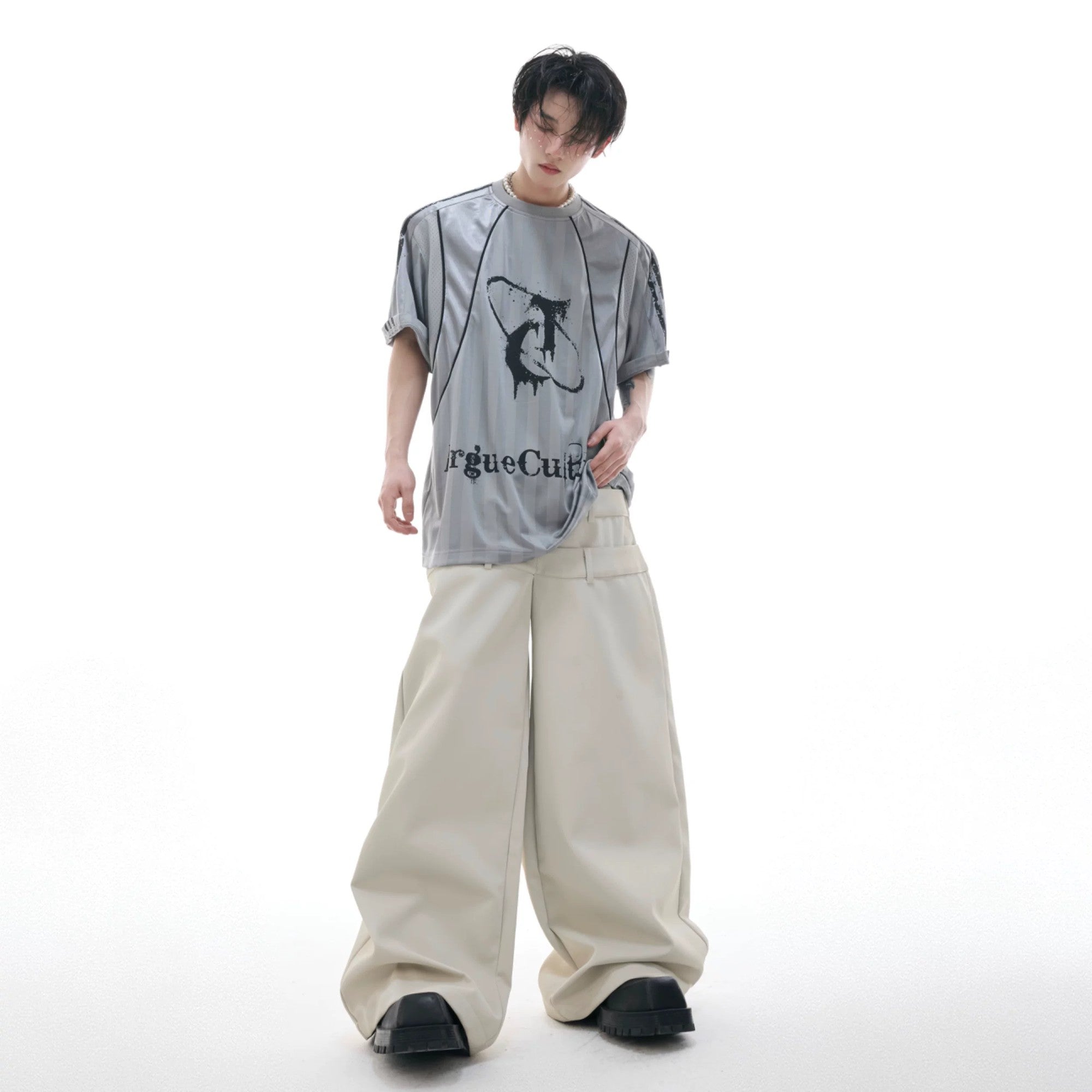 Model wearing loose fit distressed jersey tee in urban setting