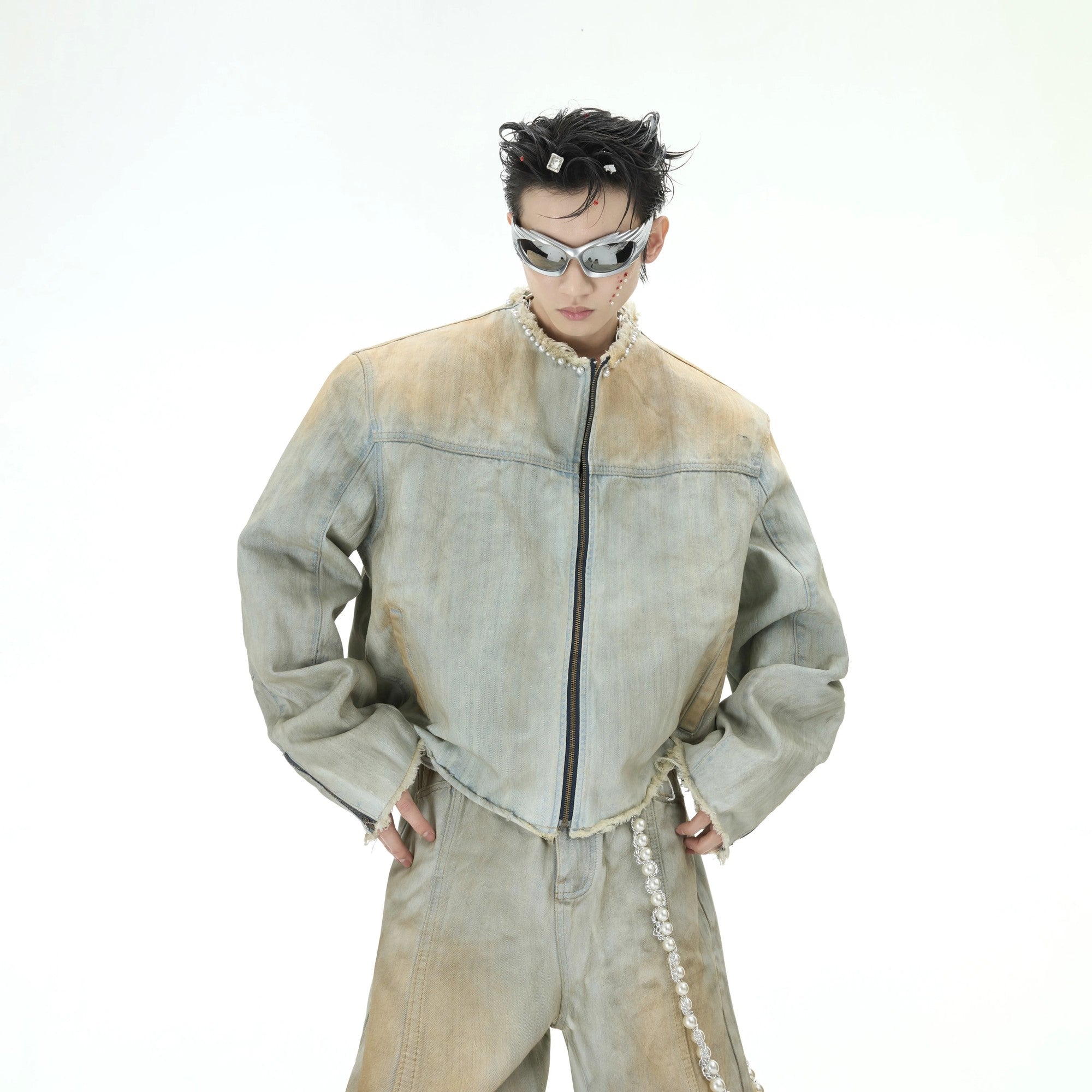 Model wearing full distressed pearl denim set in urban setting