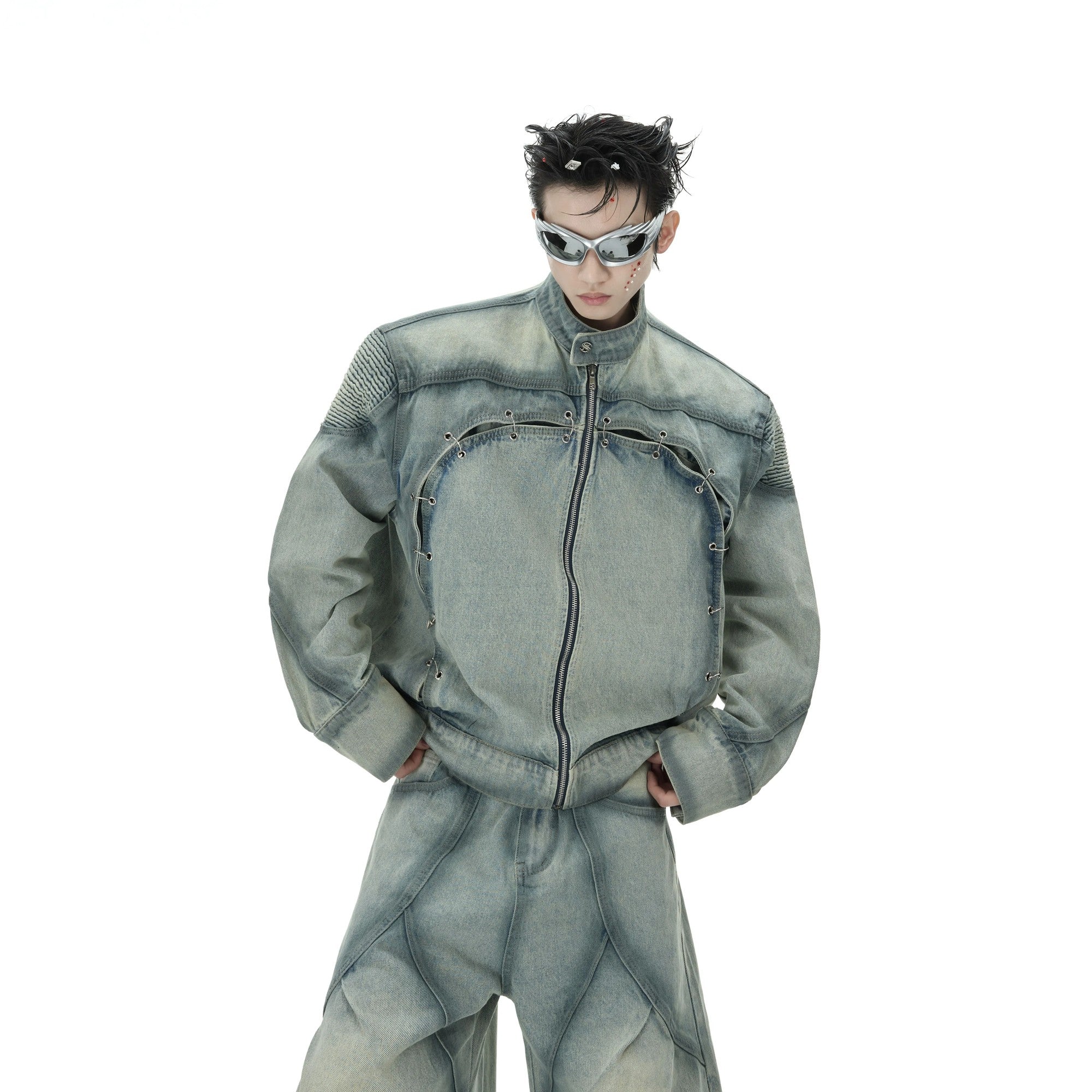 Front view of a vintage washed blue denim jacket and pants set with metal rings