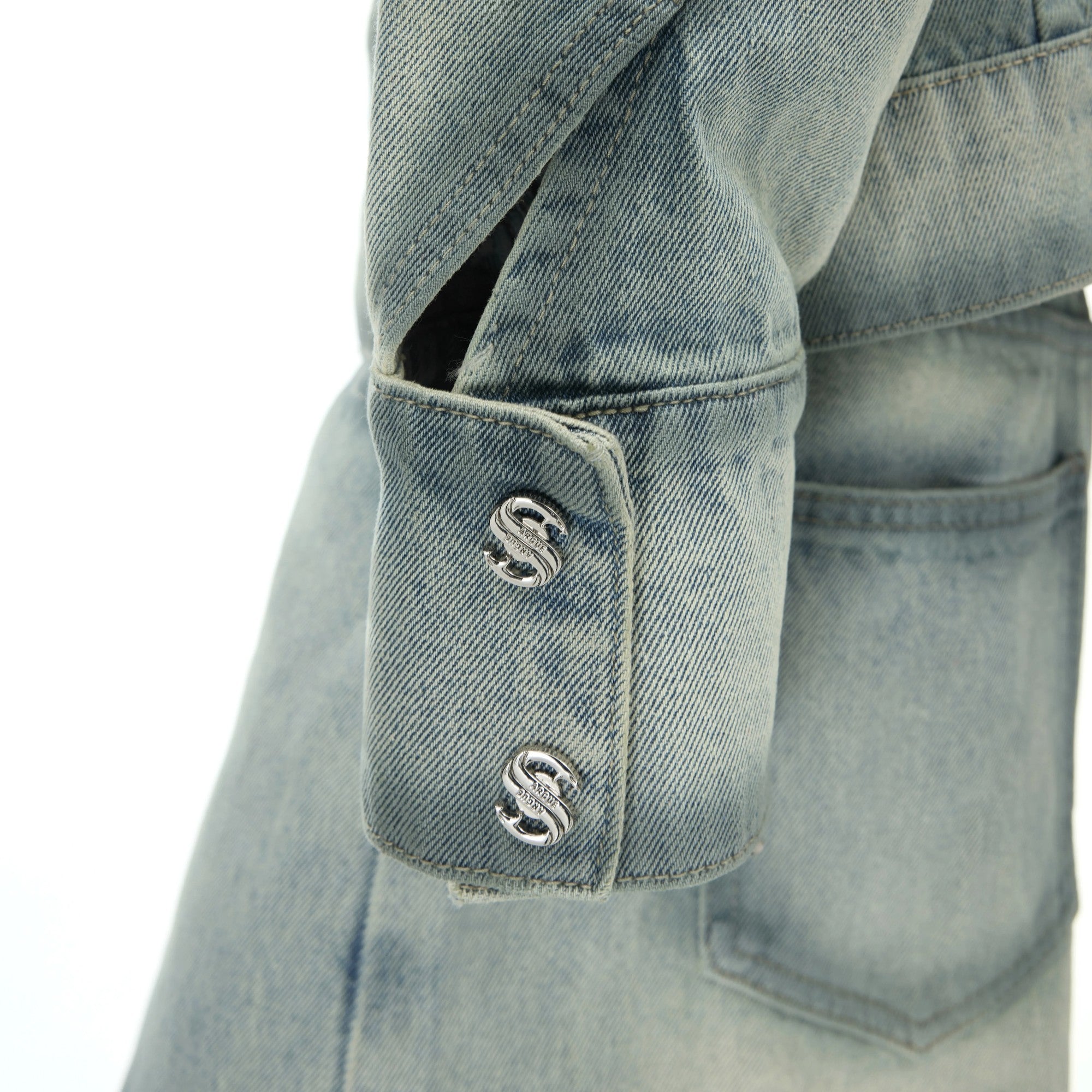 Side view of loose fit washed denim pants showing the distressed texture