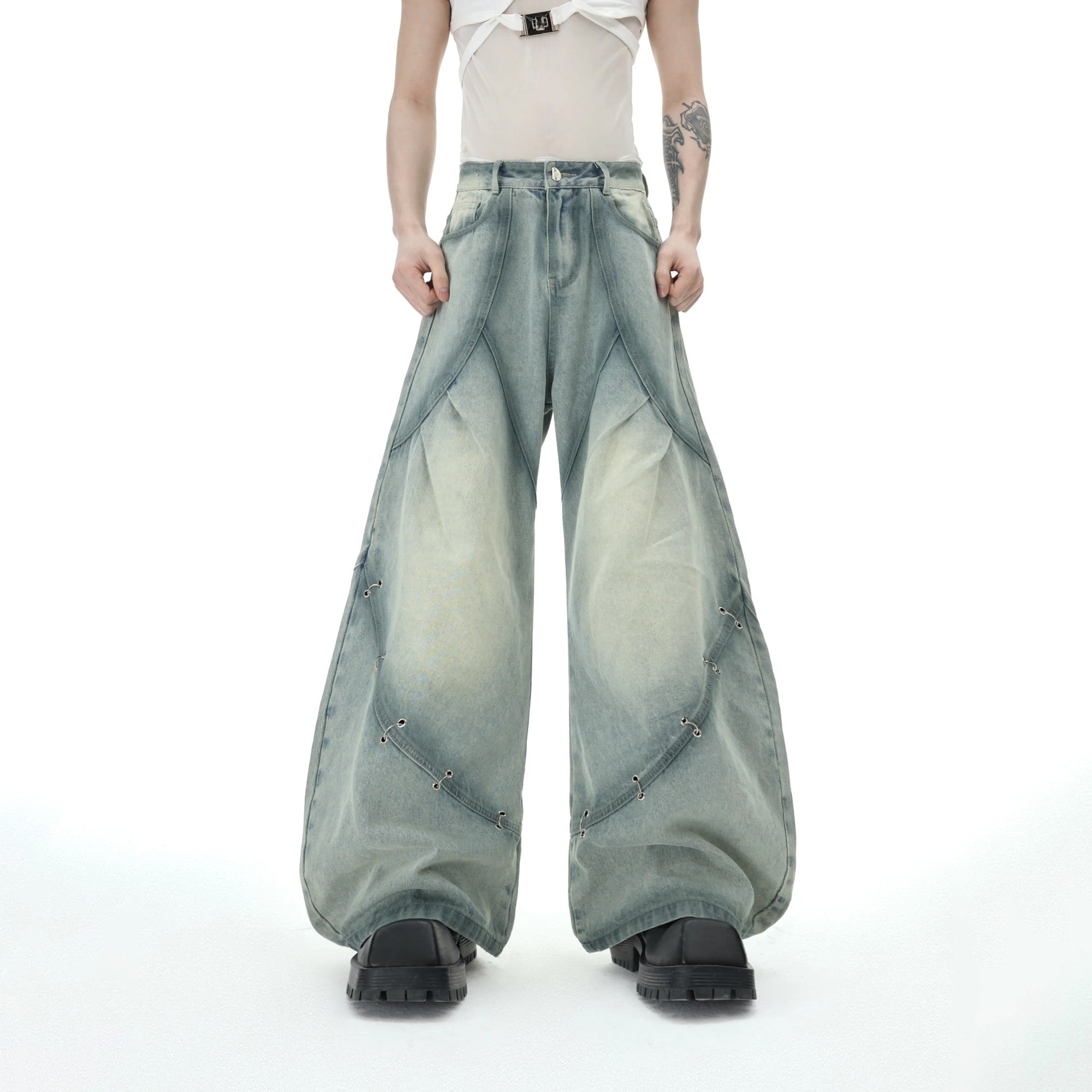 Model wearing the distressed denim set in an urban street setting