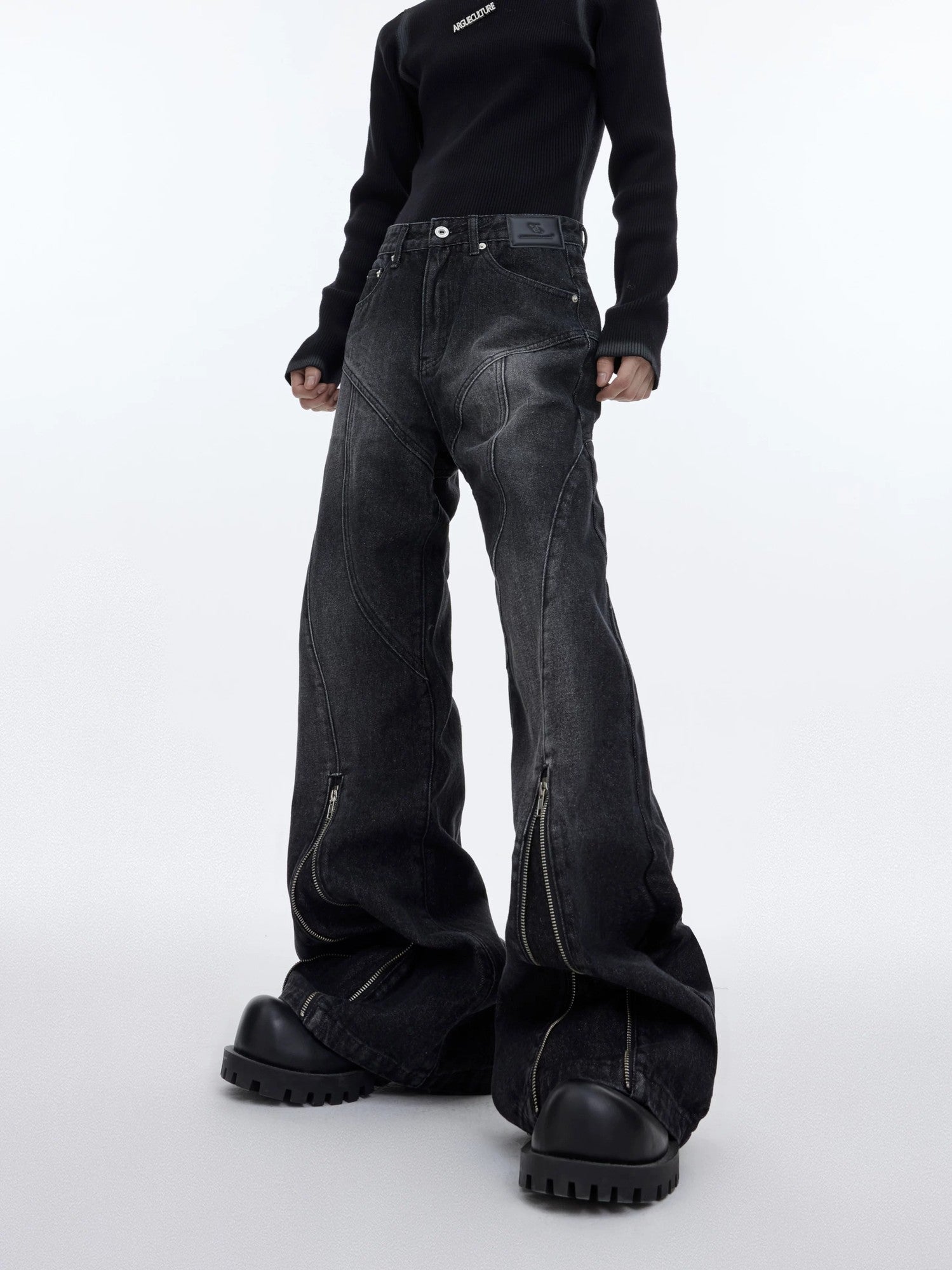 Front view of gray washed structural flared denim jeans with zipper details