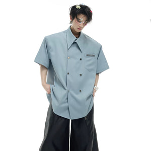 Model wearing white oversized double-breasted short sleeve shirt front view