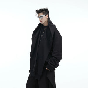 Male model wearing loose fit layered hoodie with structural shoulder pads