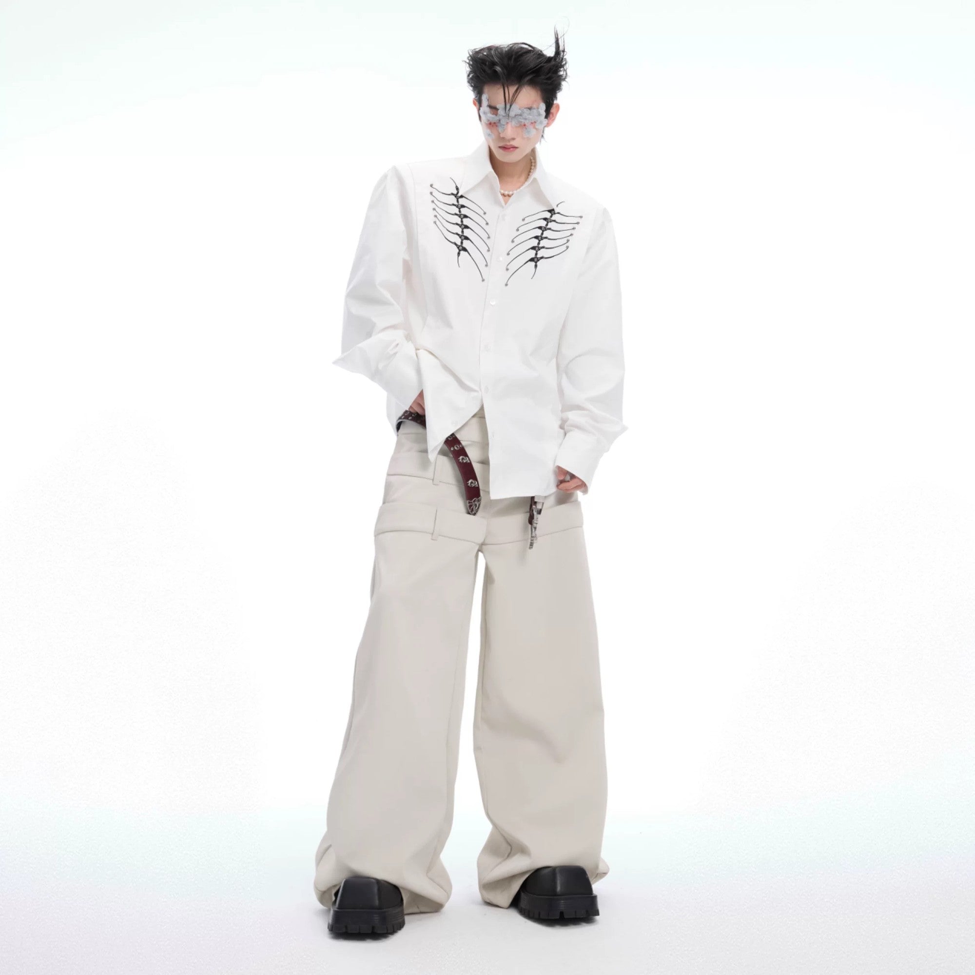 Male model wearing loose fit embroidered shirt in urban setting