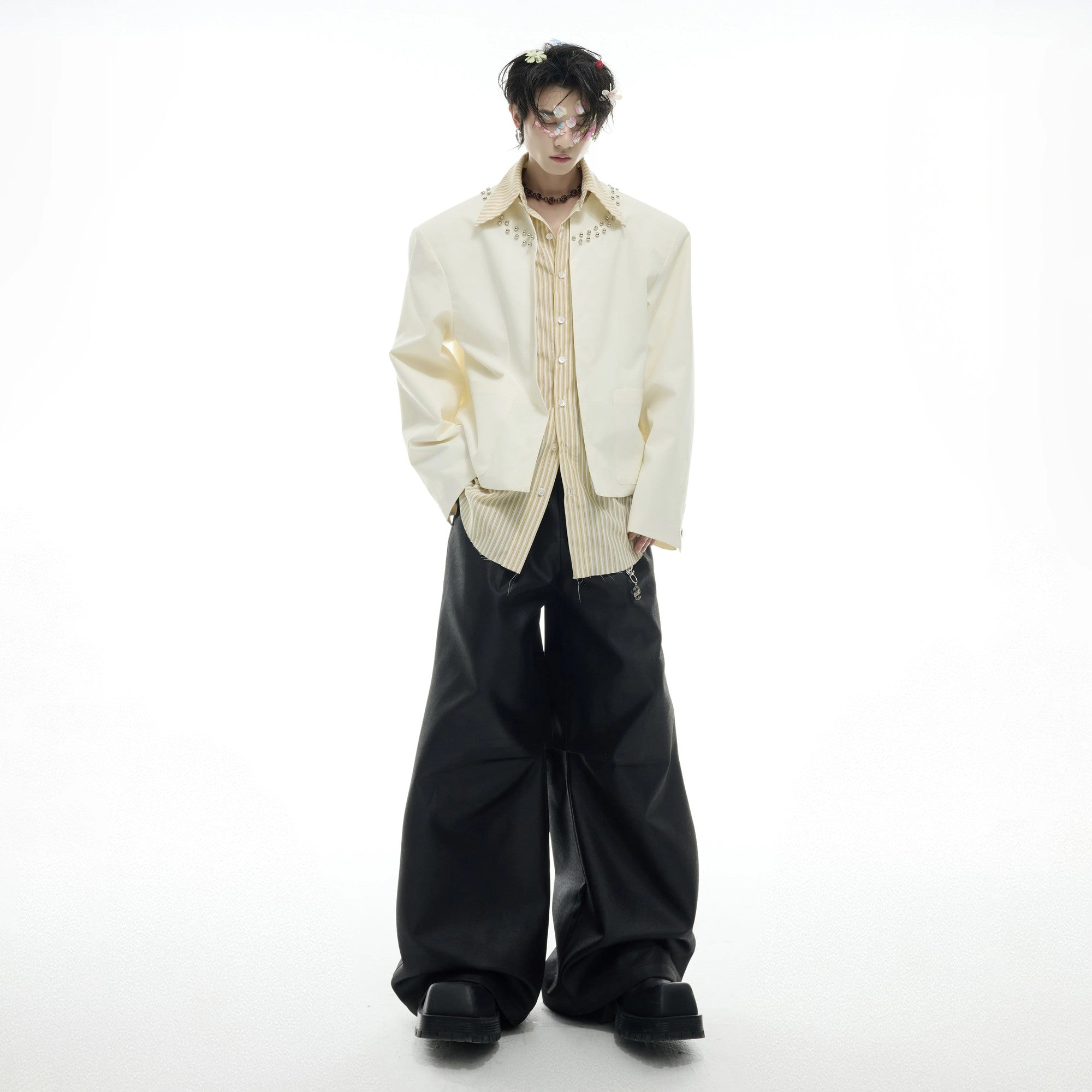 Detailed view of metal beads and hardware on shirt collar