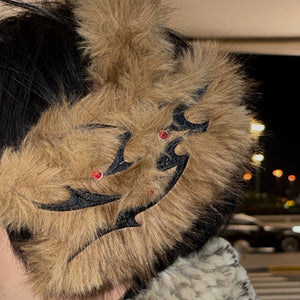 Flatlay of brown fox fur earmuffs for winter 2025