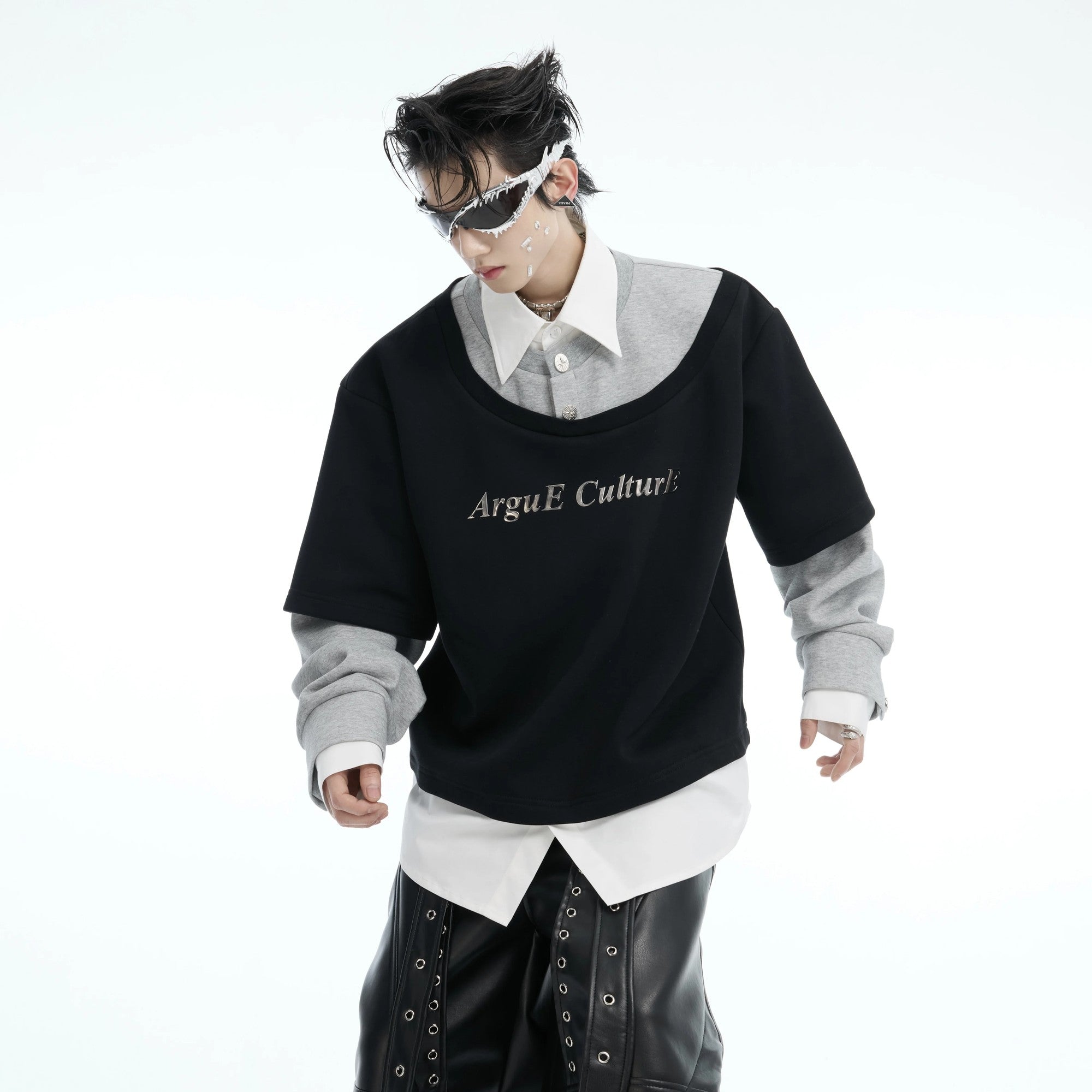 Model wearing black faux layered deconstructed sweatshirt in loose fit.