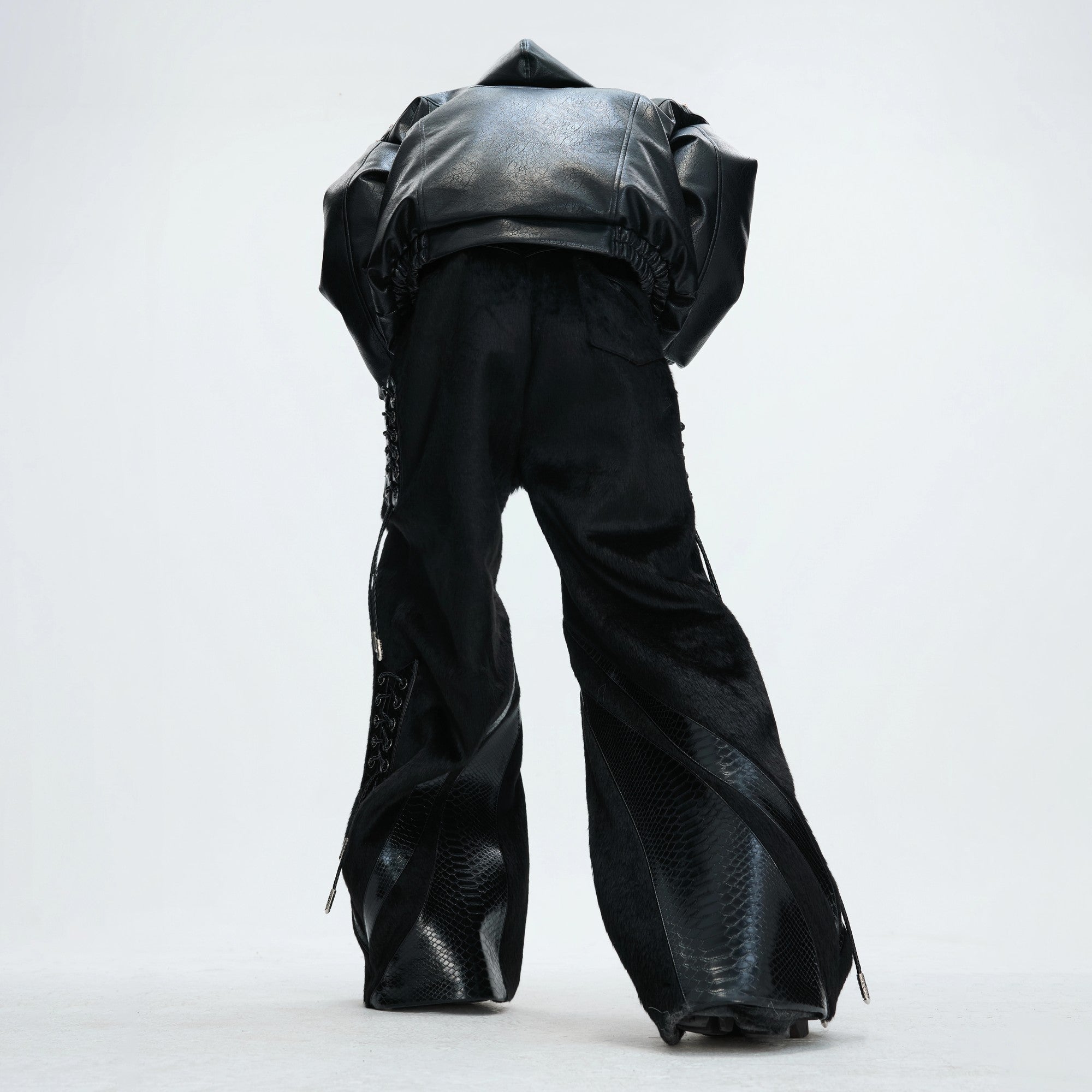 Detailed shot of the metal buckles and removable straps on the side of the pants.