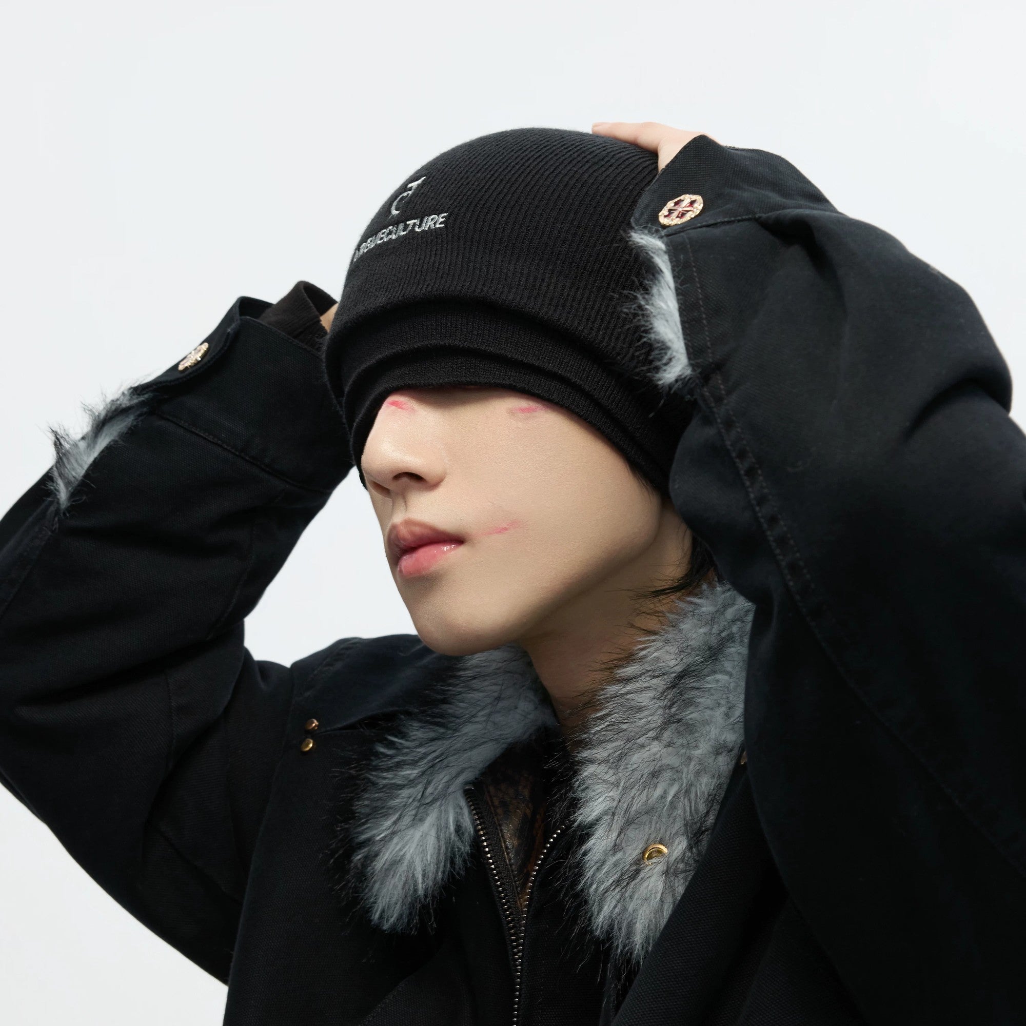 Model wearing the triple layer beanie in a winter urban setting