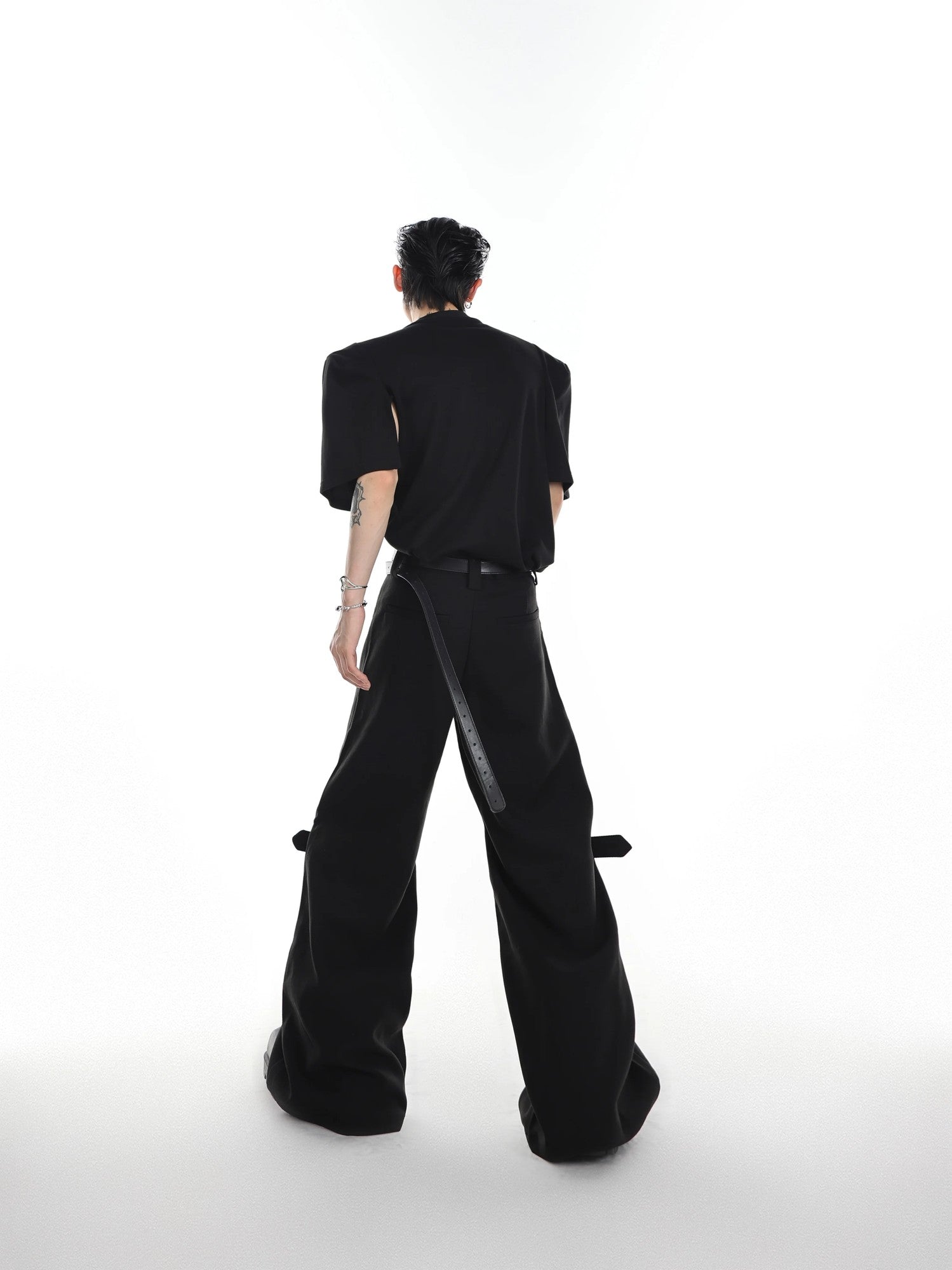 Model wearing high-waist flared twill trousers for a modern streetwear look.