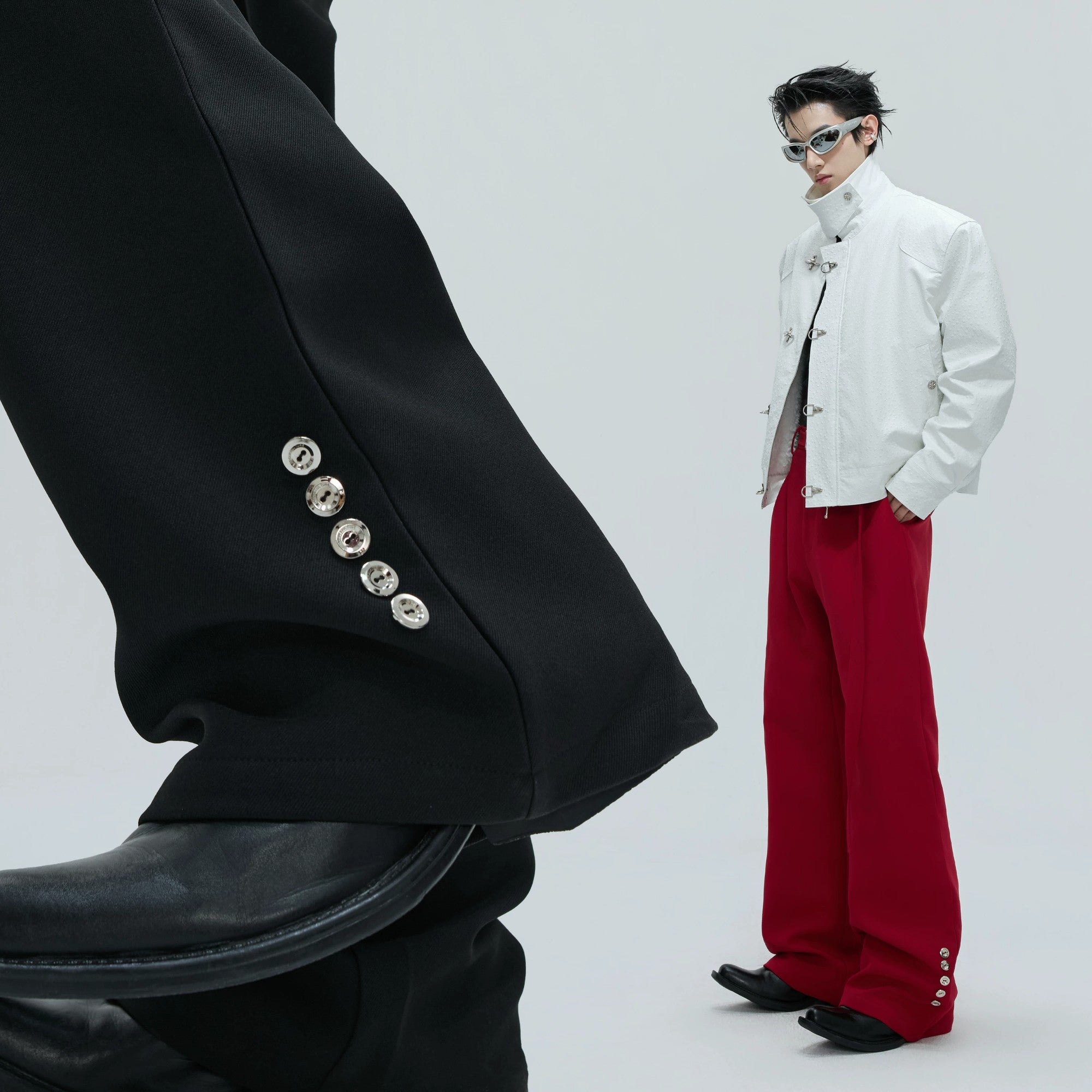 Close up of industrial metal button hardware on trousers