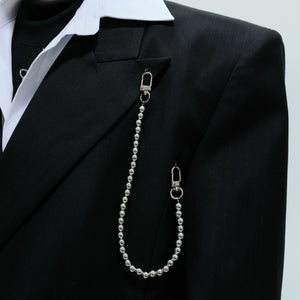 Silver metal chain detail on a black double breasted blazer