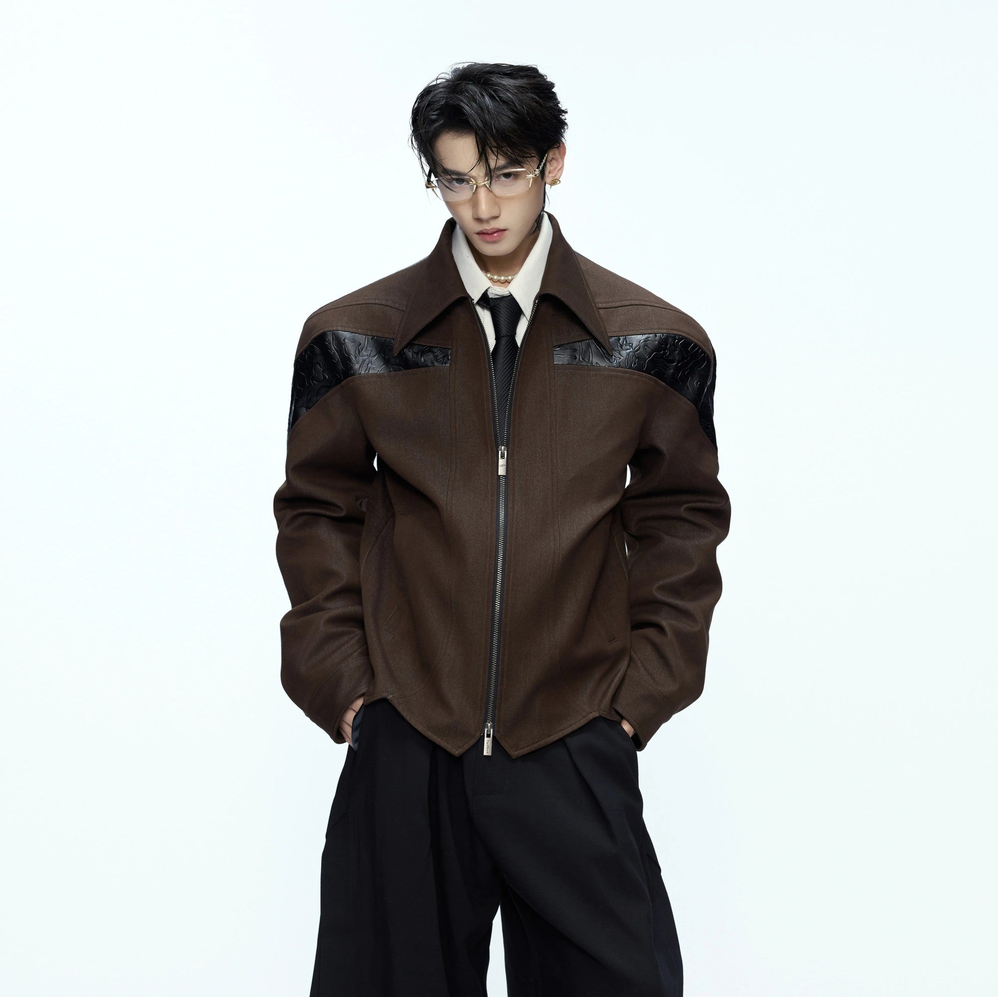 Close-up of the textured leather and patchwork stitching details.