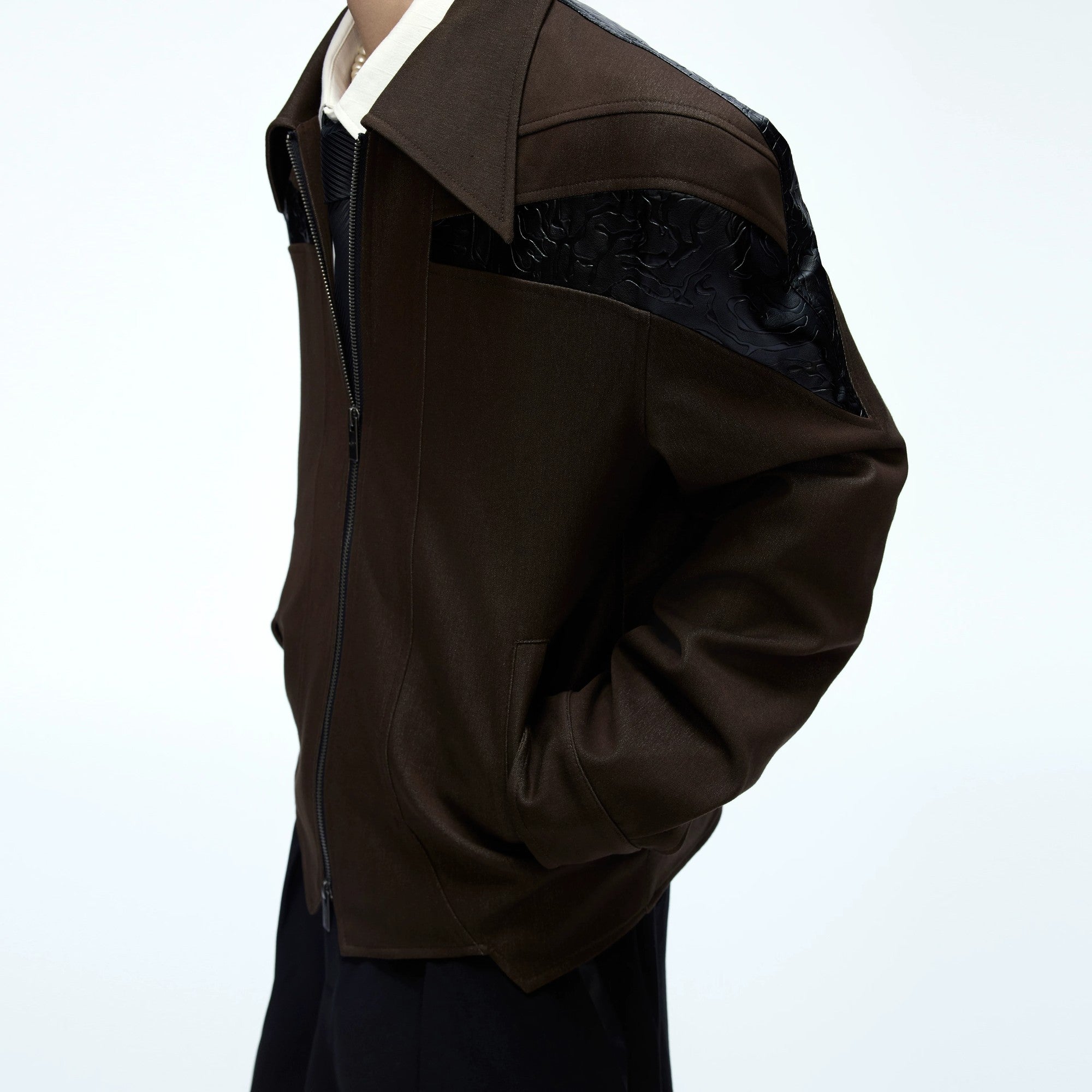 Male model wearing the deconstructed cropped jacket with baggy pants.