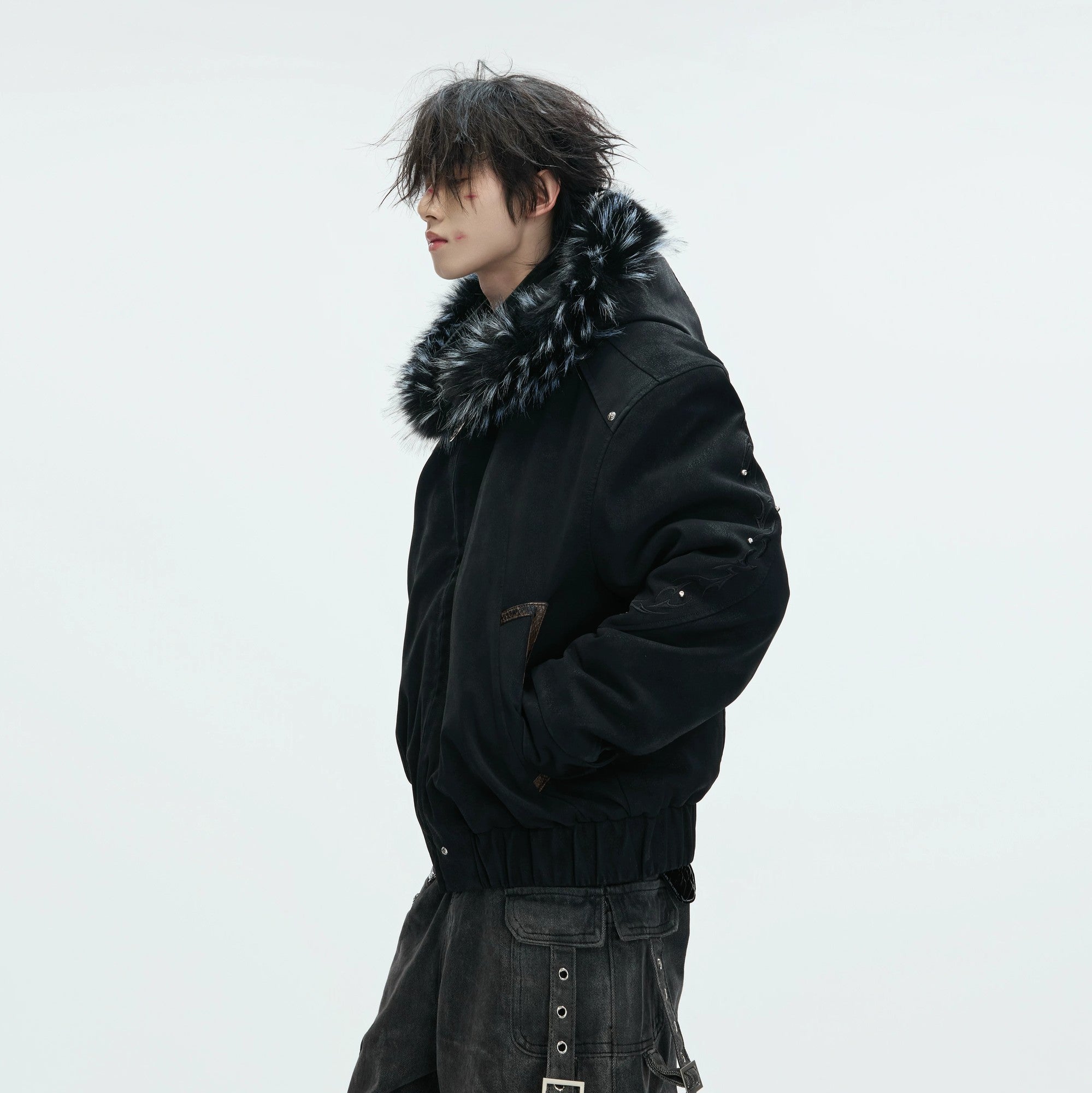 Model wearing a heavy embroidered leather jacket in a street setting