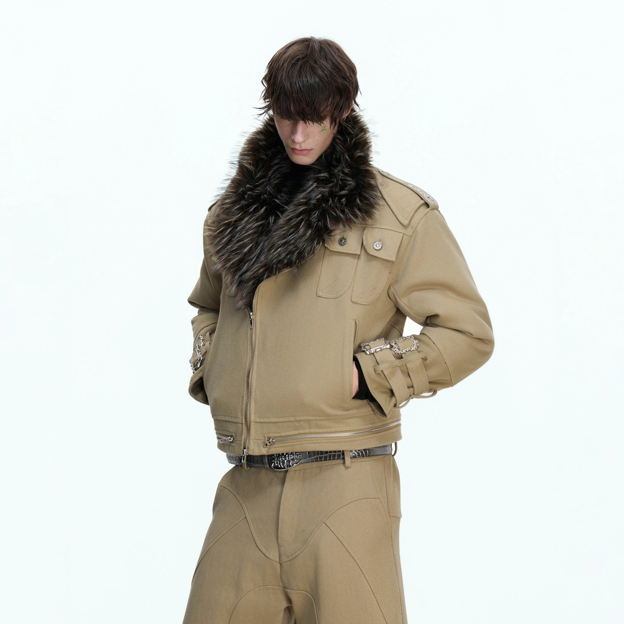 Close-up of the distressed patchwork and stitching on the canvas jacket.