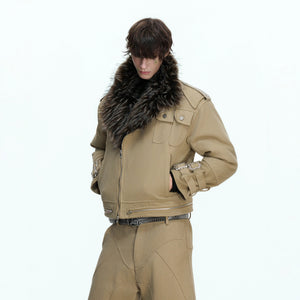 Close-up of the distressed patchwork and stitching on the canvas jacket.