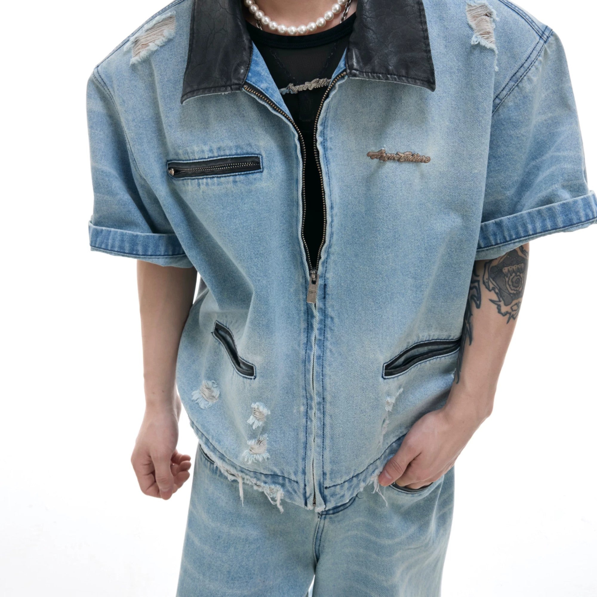 Detailed shot of faux leather splicing on the denim jacket collar