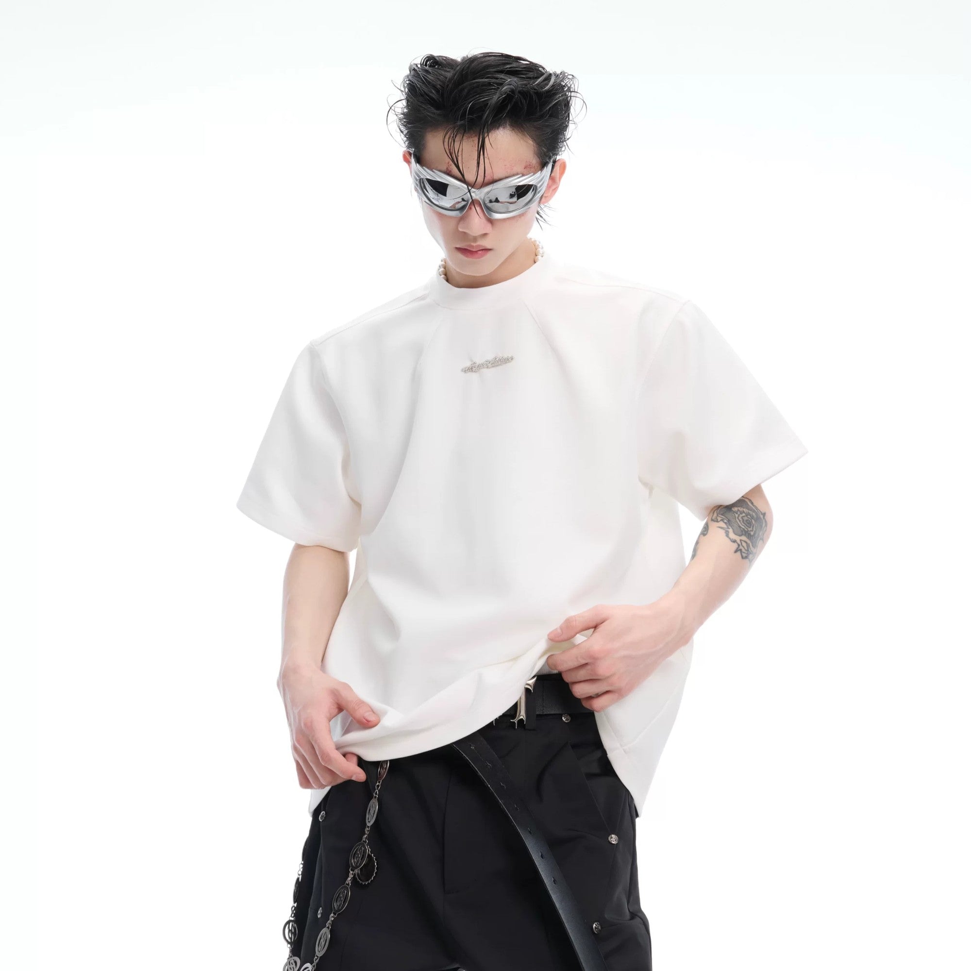 Detailed shot of premium metal accents on the crewneck collar