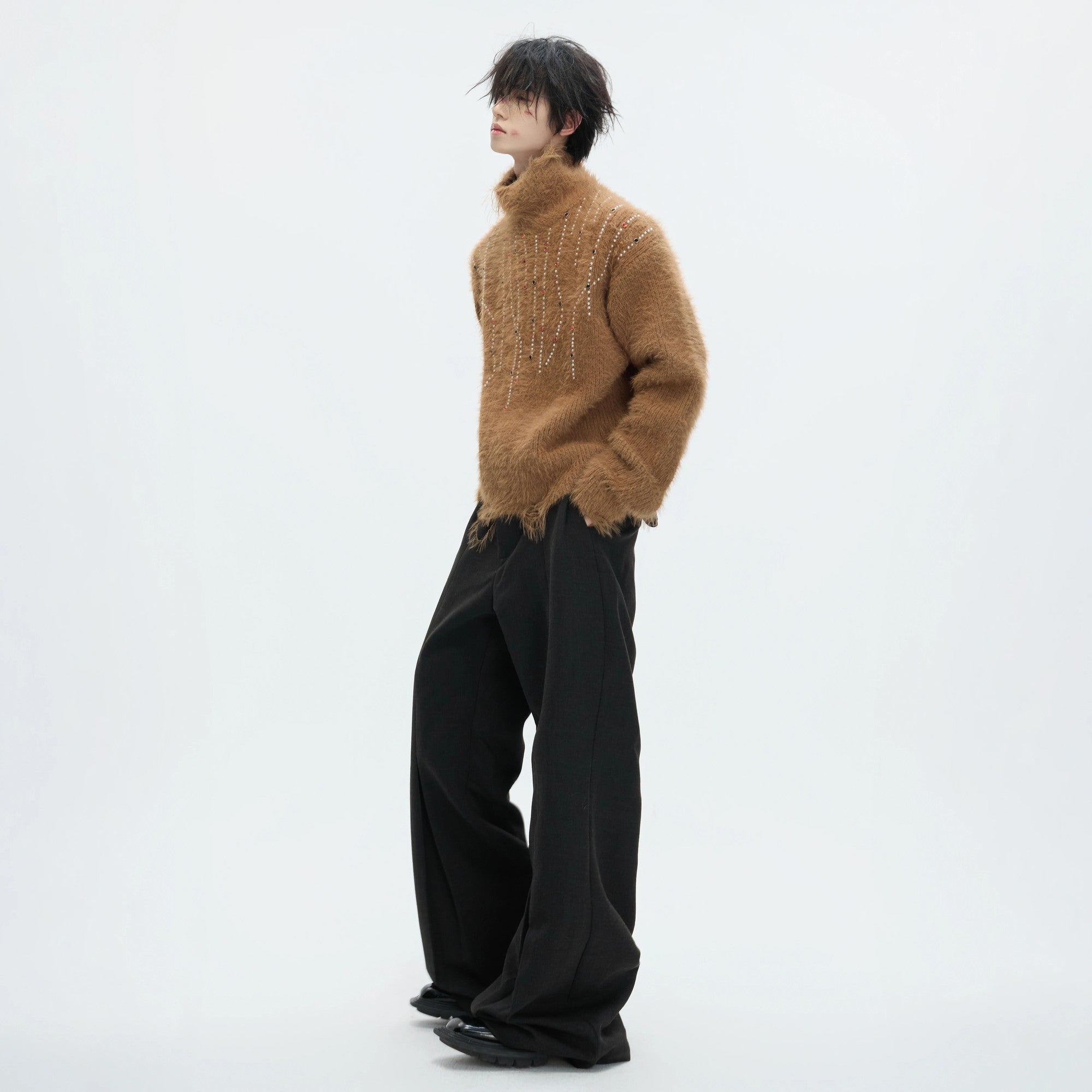 Model wearing a green oversized heavyweight turtleneck in a street setting