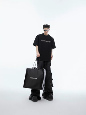 Detail shot of the silver-plated 3D metal logo on the chest