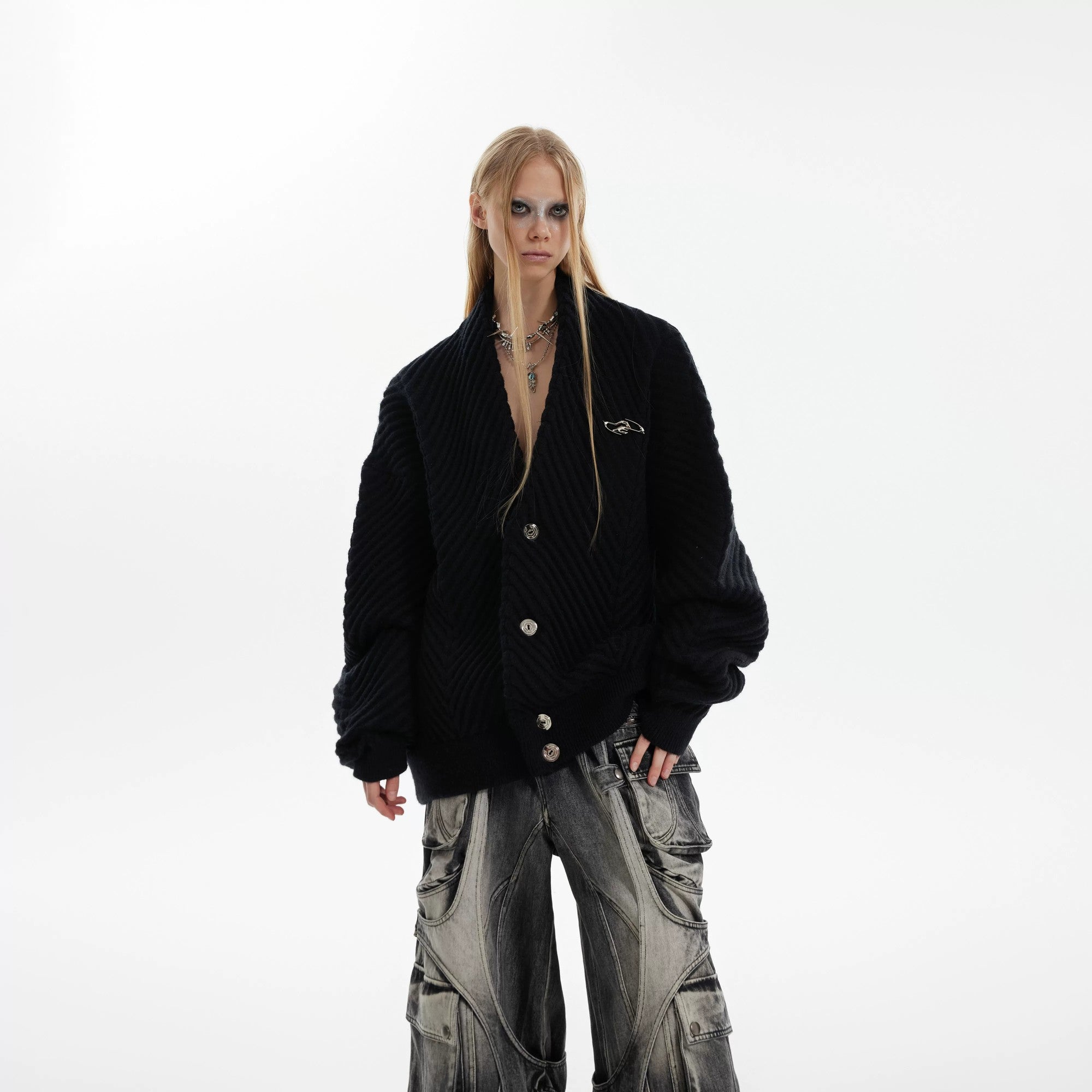 Model wearing a brown oversized ribbed cardigan in an urban setting