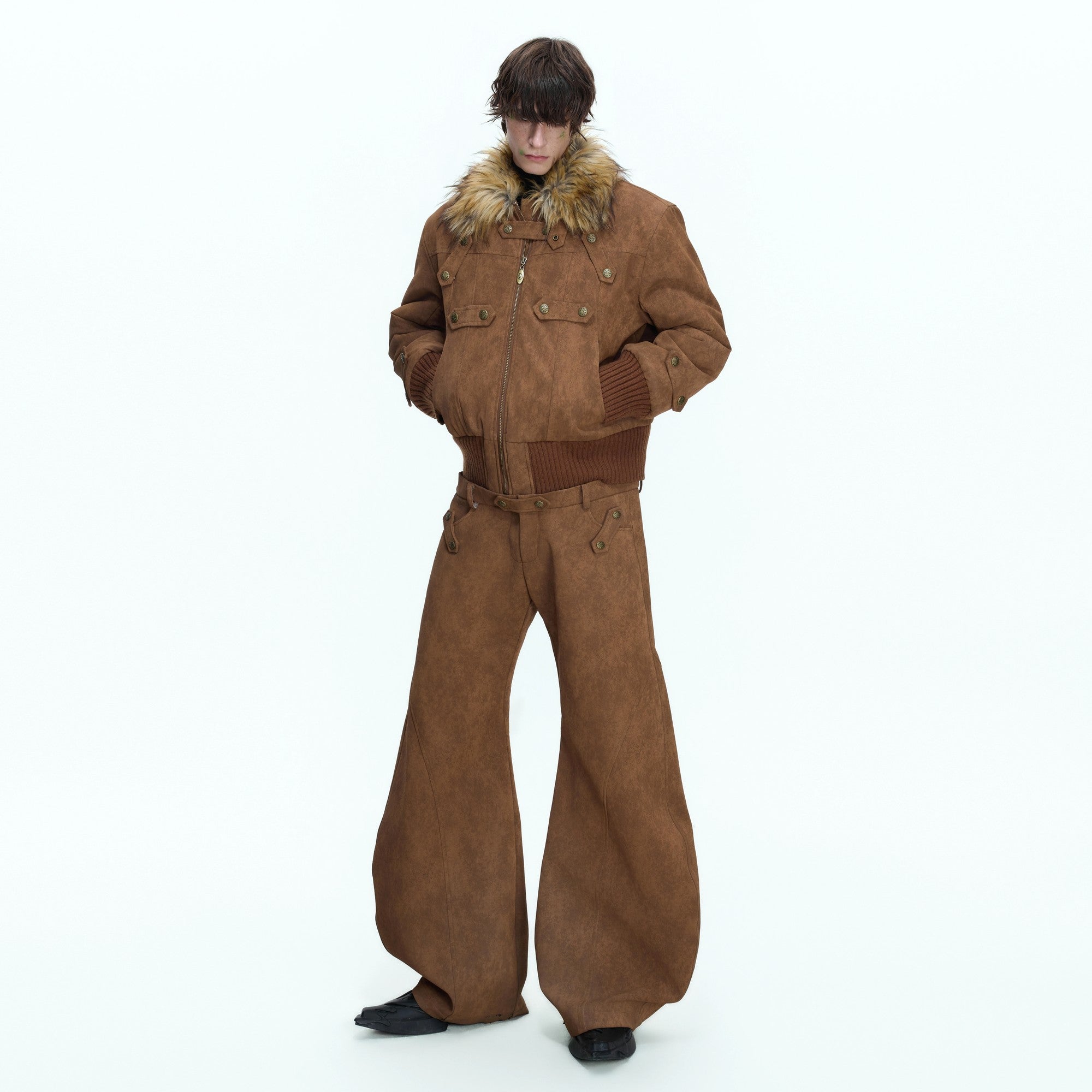 Back view of deconstructed suede pants with custom metal hardware