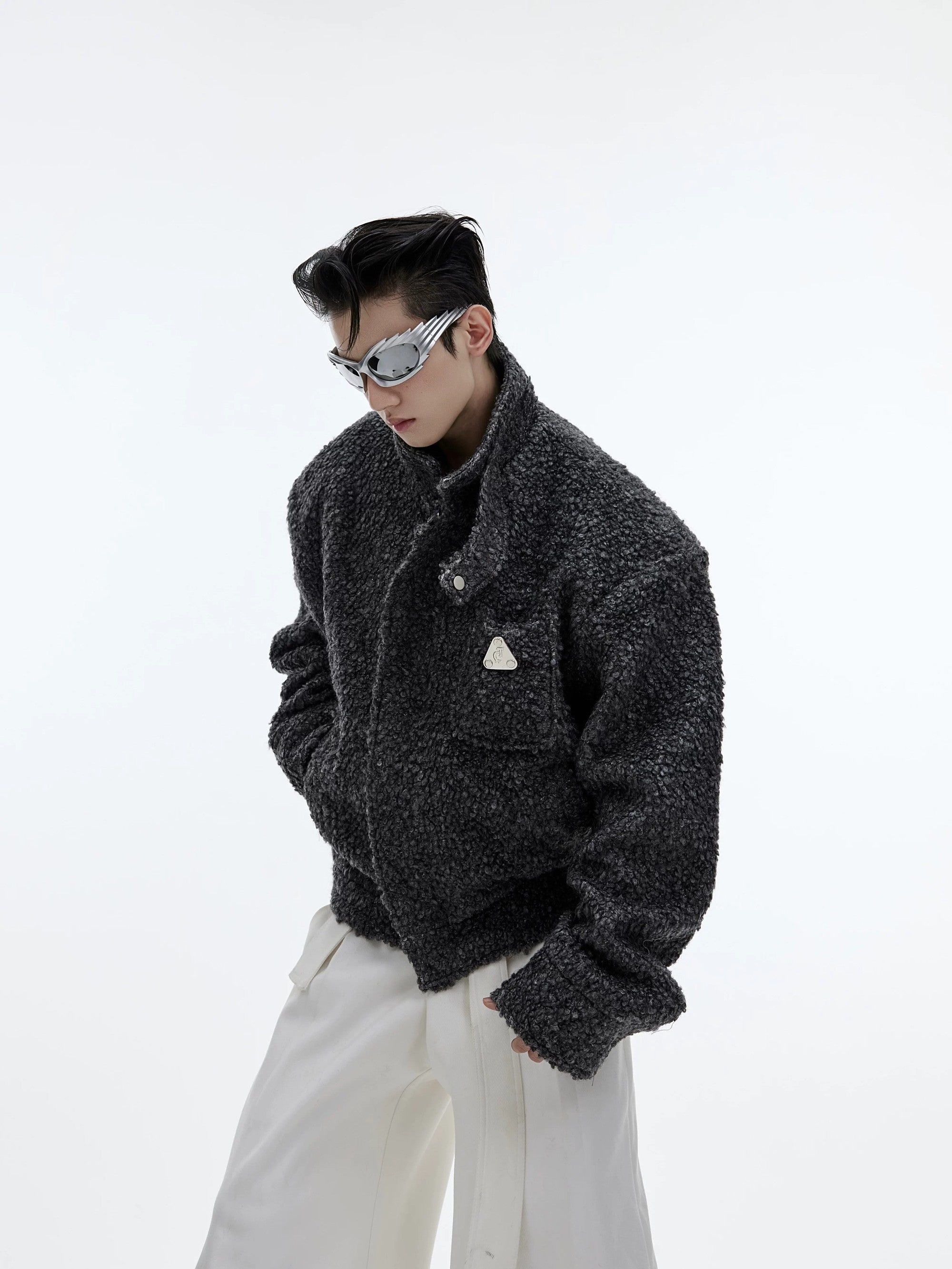Back view of white boxy cropped jacket showing textured fabric