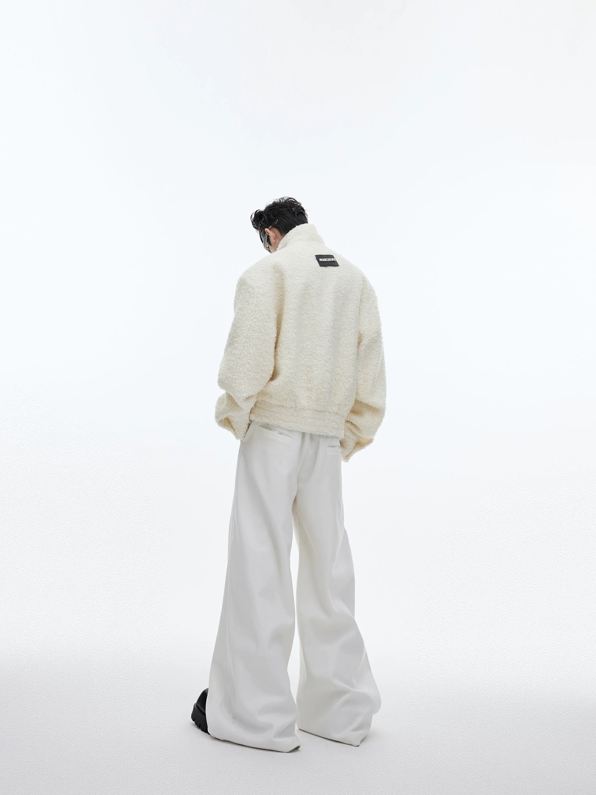 Model wearing textured cropped jacket with wide leg pants