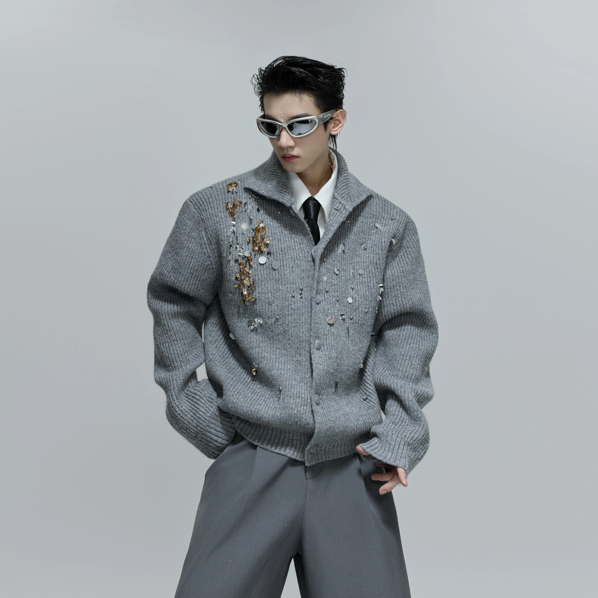 Model wearing the gray relaxed fit sequin sweater in a street setting