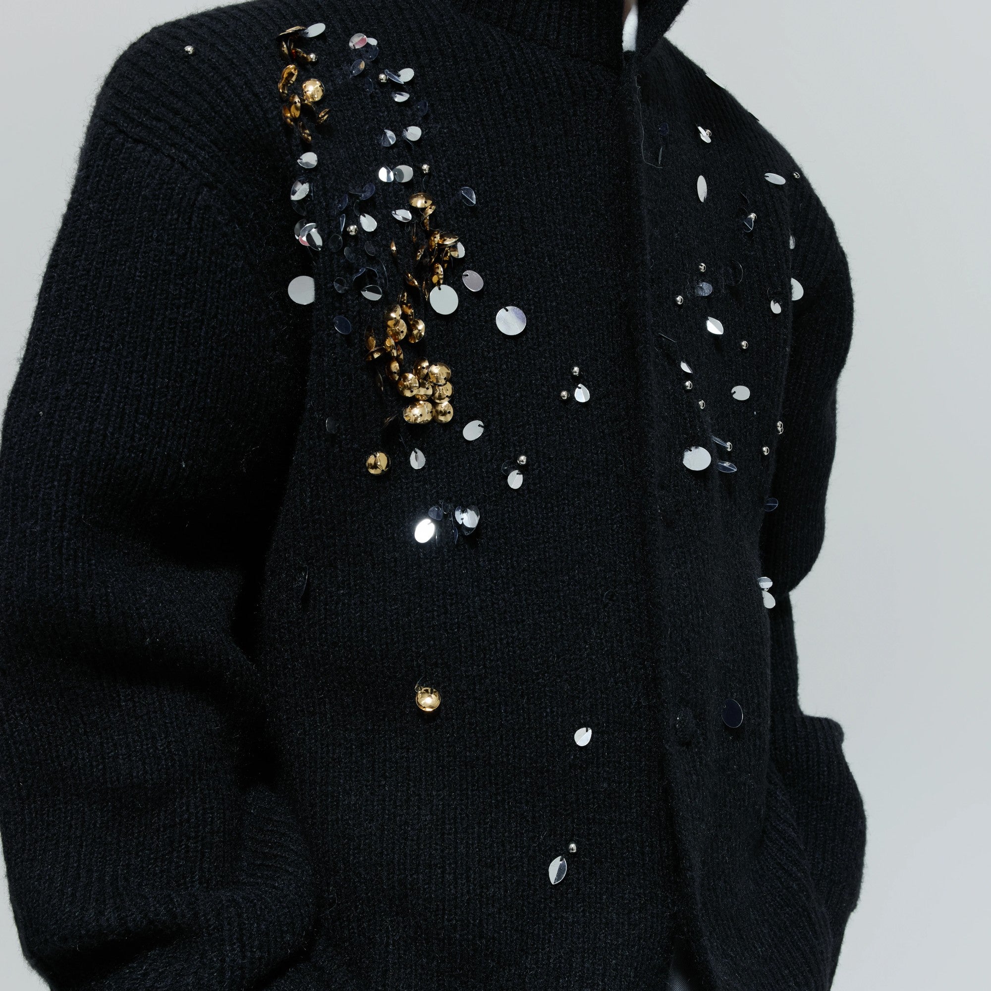 Back view showing the relaxed drape and high-neck design of the sweater