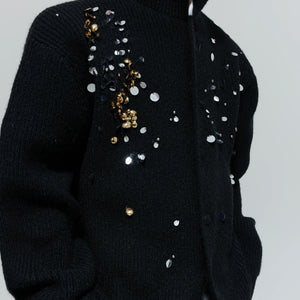 Back view showing the relaxed drape and high-neck design of the sweater