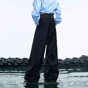 Close-up of the double-layer deconstructed waist design on black pants