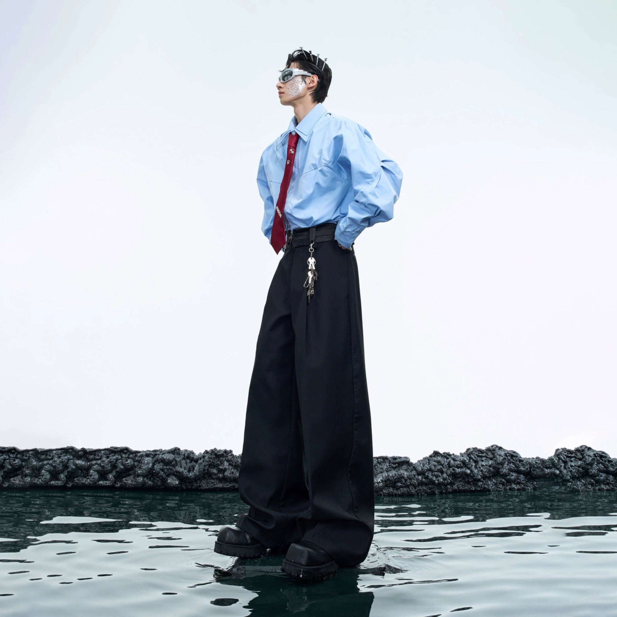 Model wearing black deconstructed flare pants with streetwear aesthetic