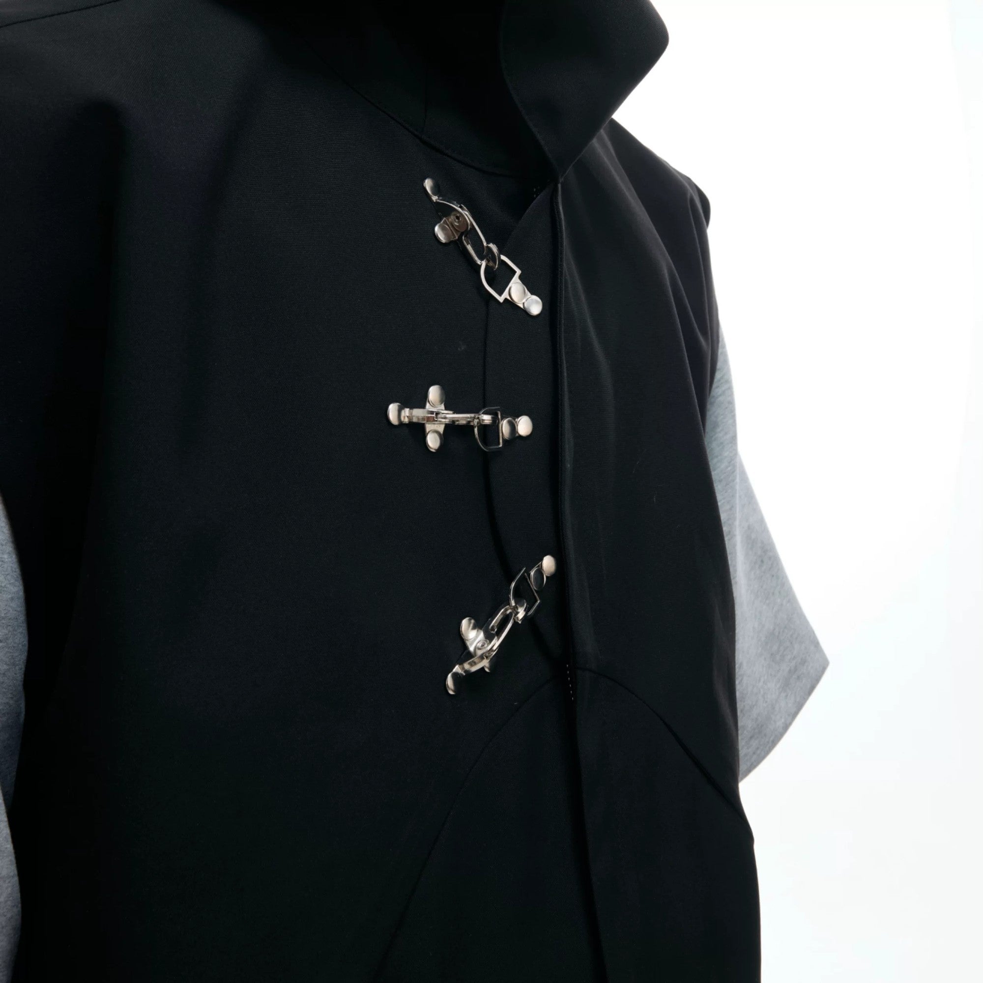 Flat lay of the black and white hooded vest and pants set