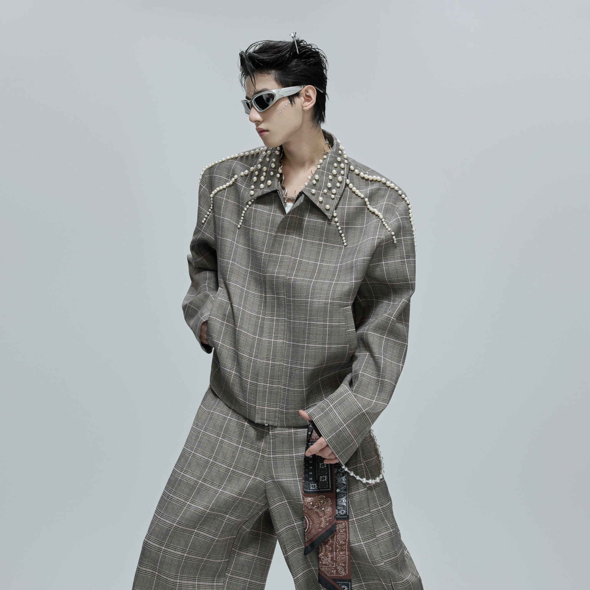 Close up of pearl design on the lapel of a houndstooth jacket