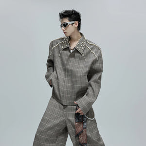 Close up of pearl design on the lapel of a houndstooth jacket