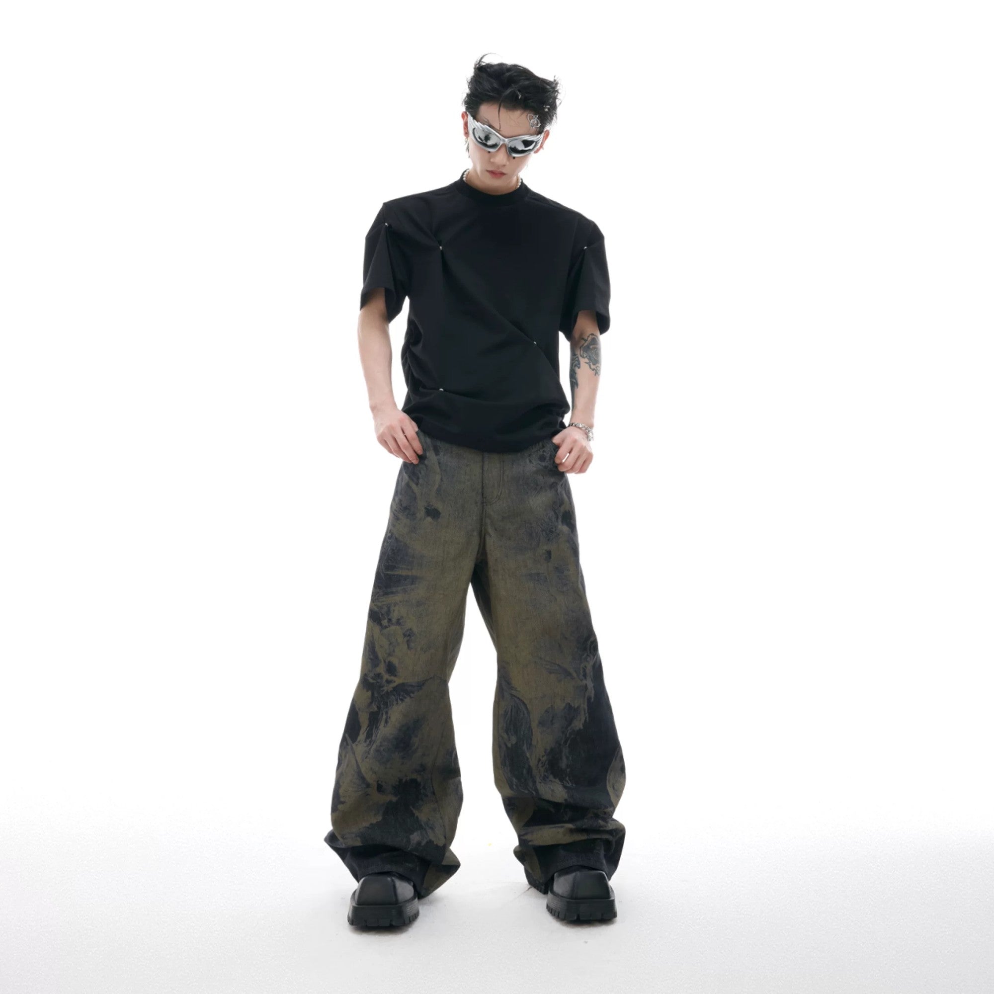 Model wearing laser engraved baggy jeans in a city street setting